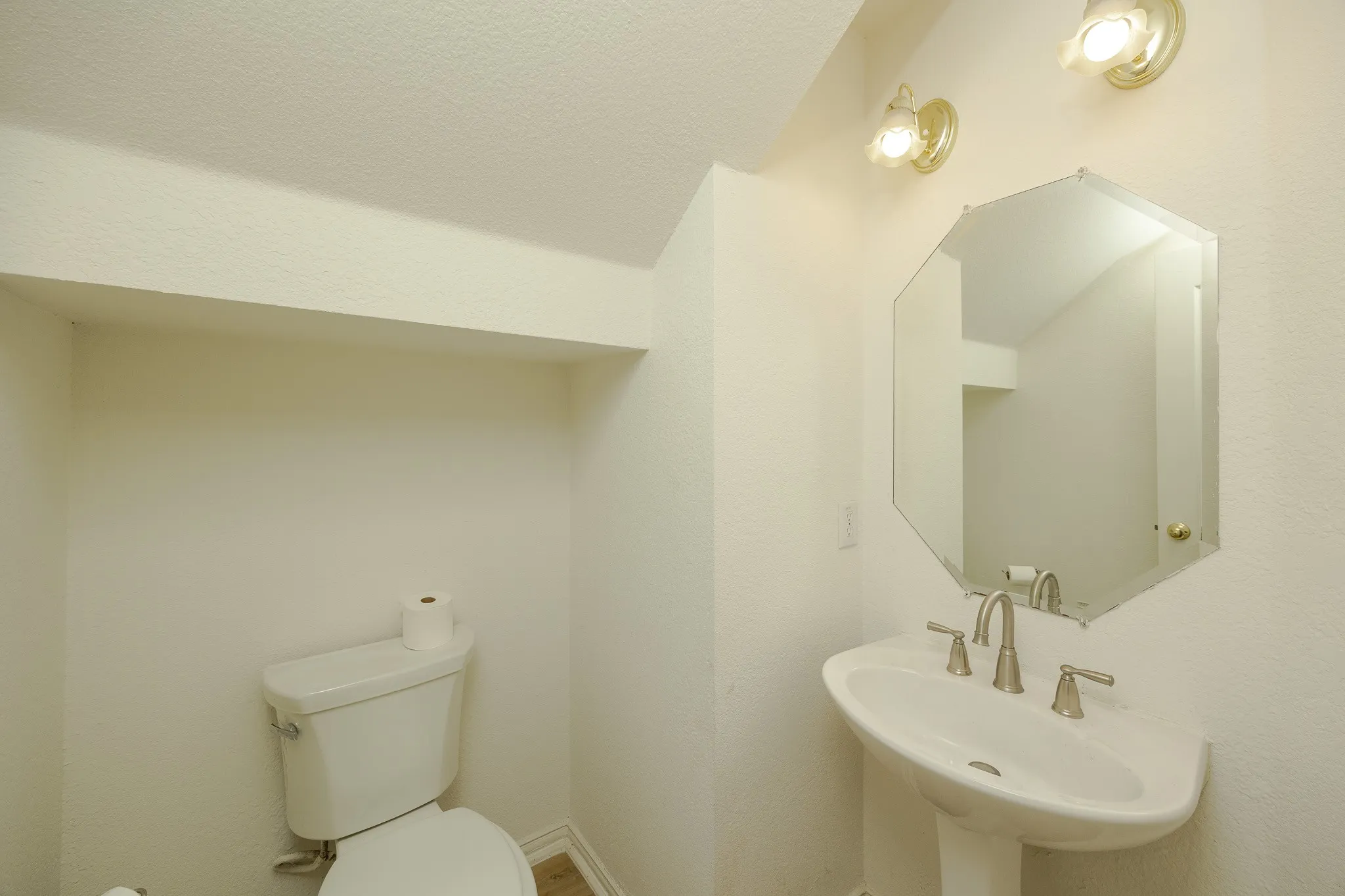 Half bath with a sink and toilet