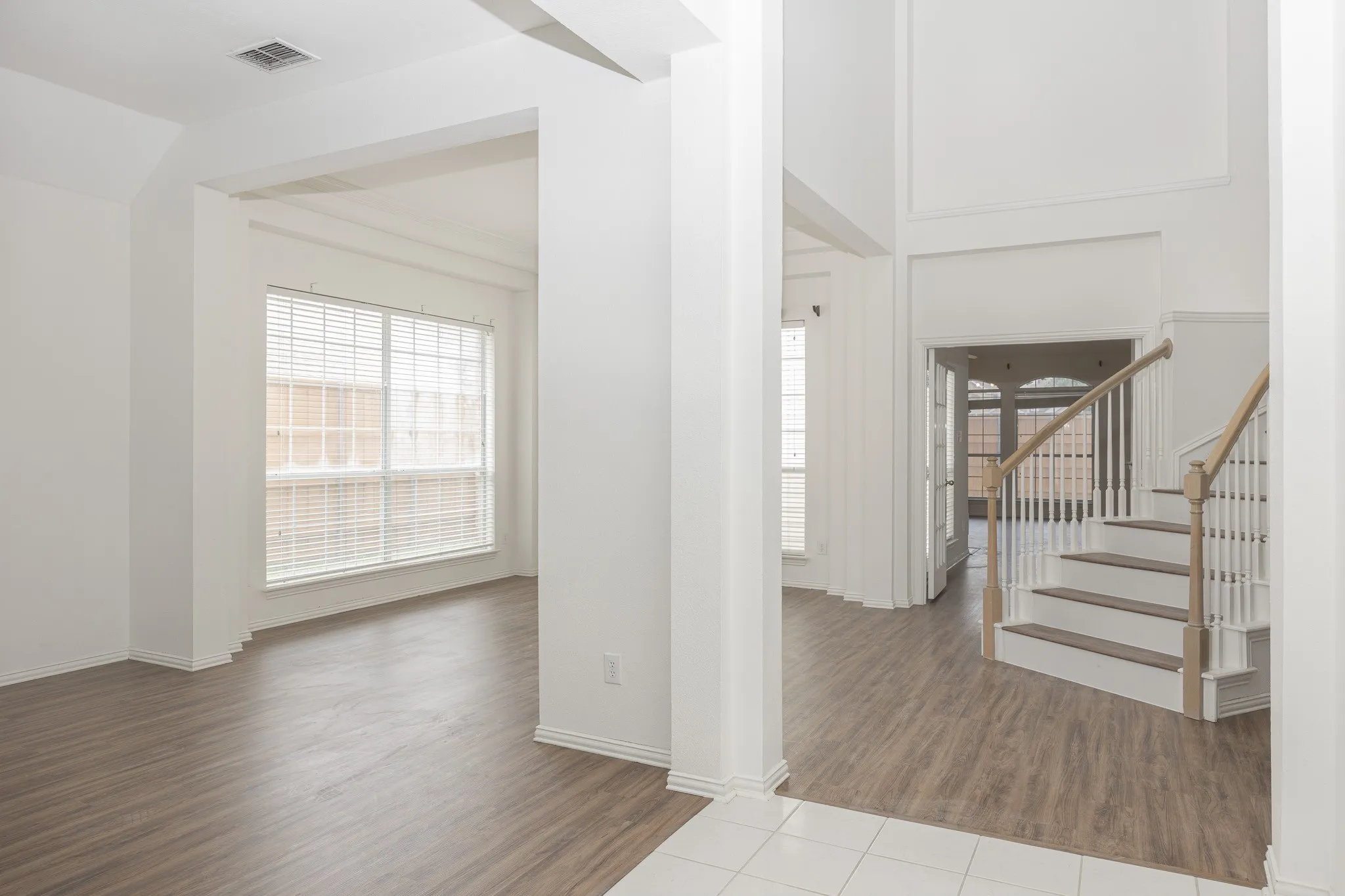 Foyer with stairway and wood finished floors