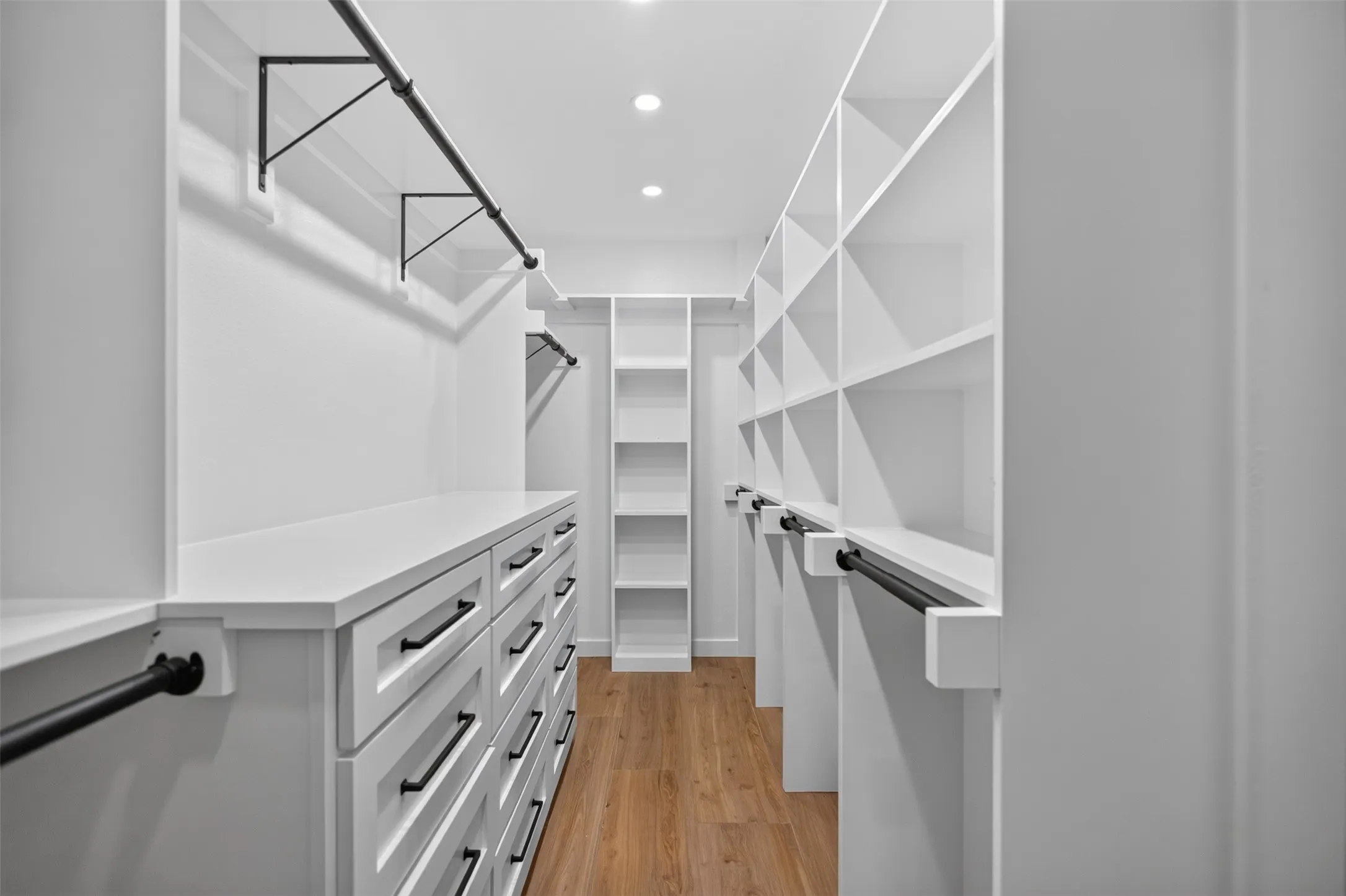 Primary Bedroom Closet with modern built-in Dressers and lots of storage area