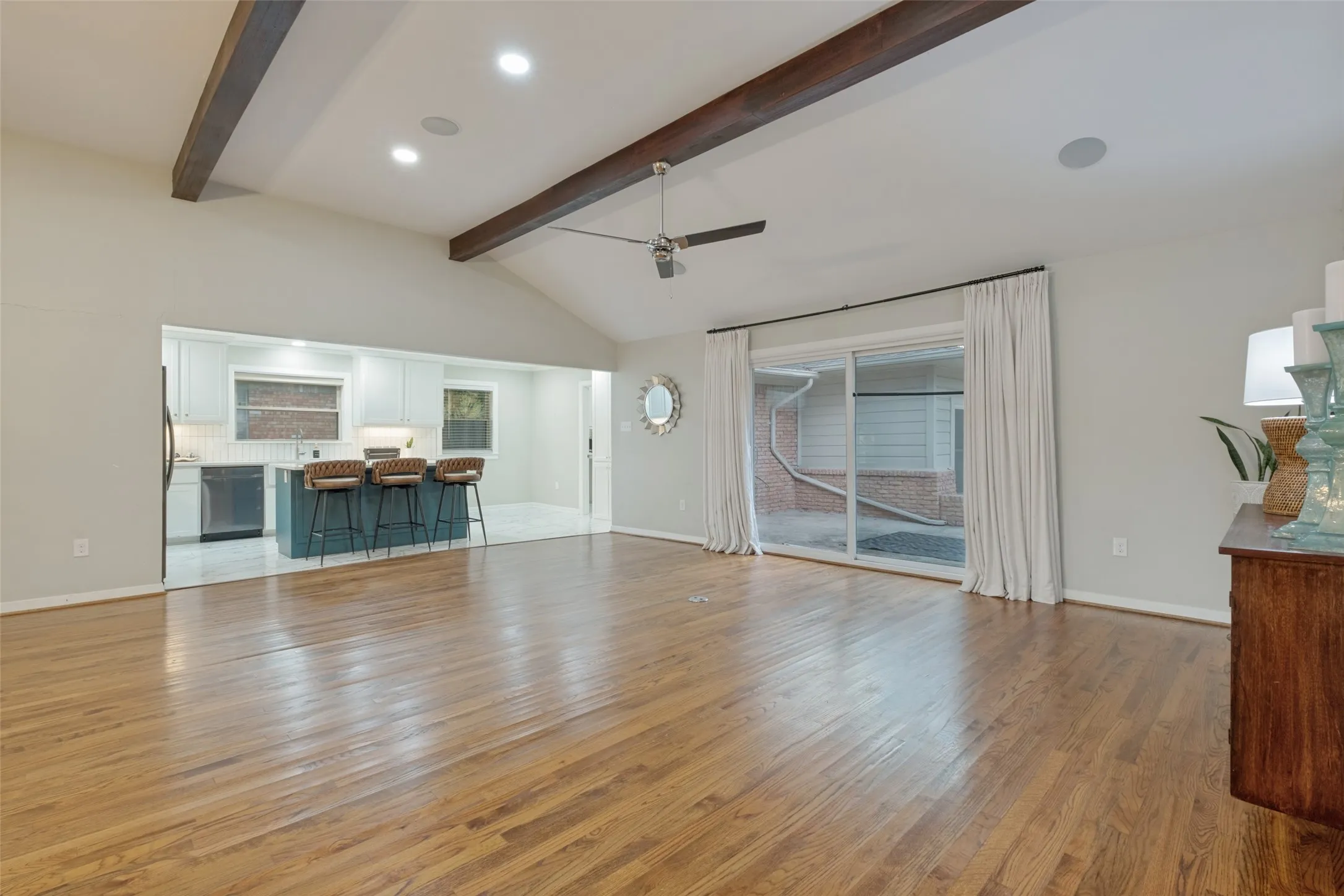 Gorgeous Stained Beams highlight the tall vaulted ceilings and bright windows and large back door creates a warm and space to entertain.