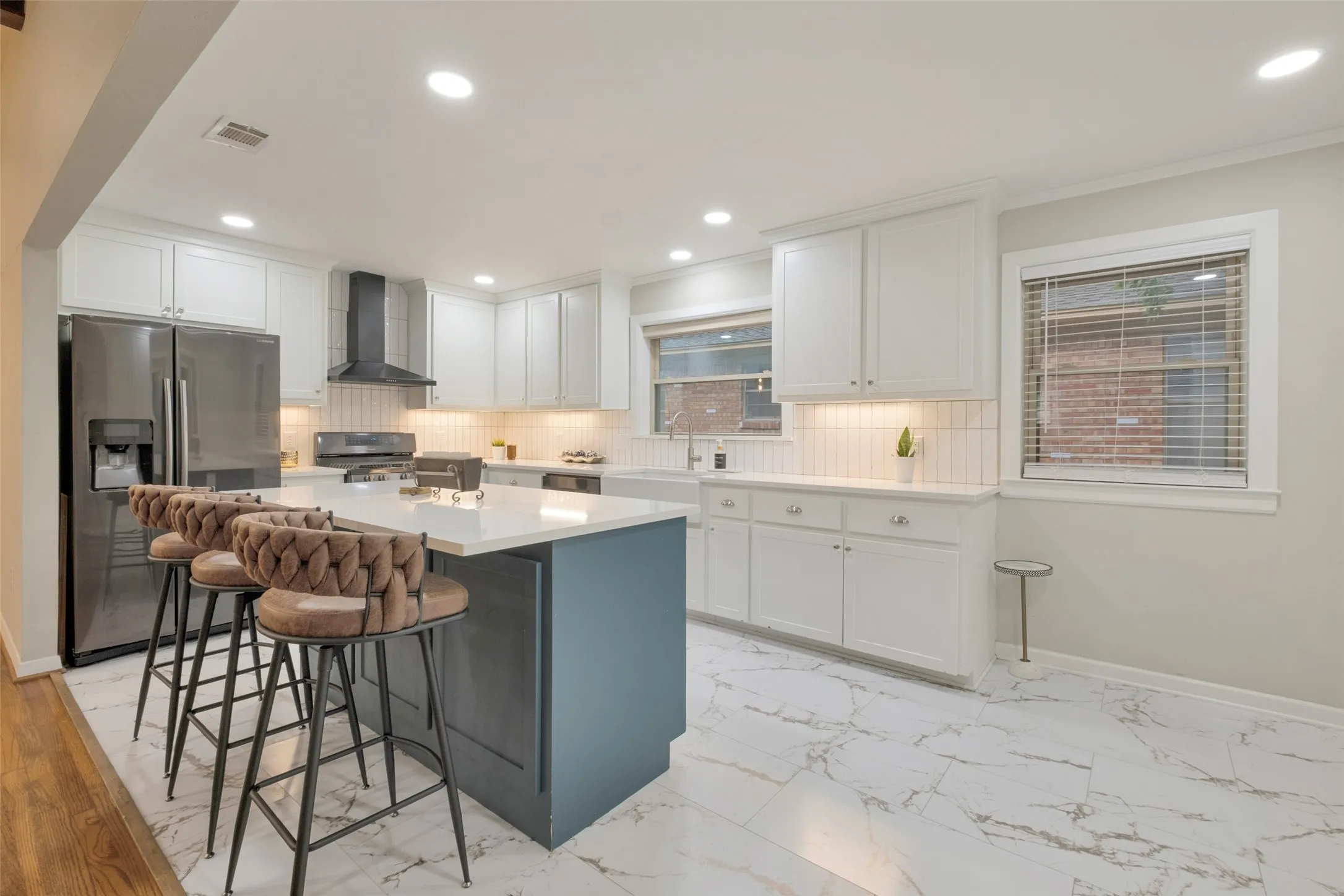 Large Island with luxury quartz countertops & luxury vinyl flooring adorns this elegant & bright kitchen.