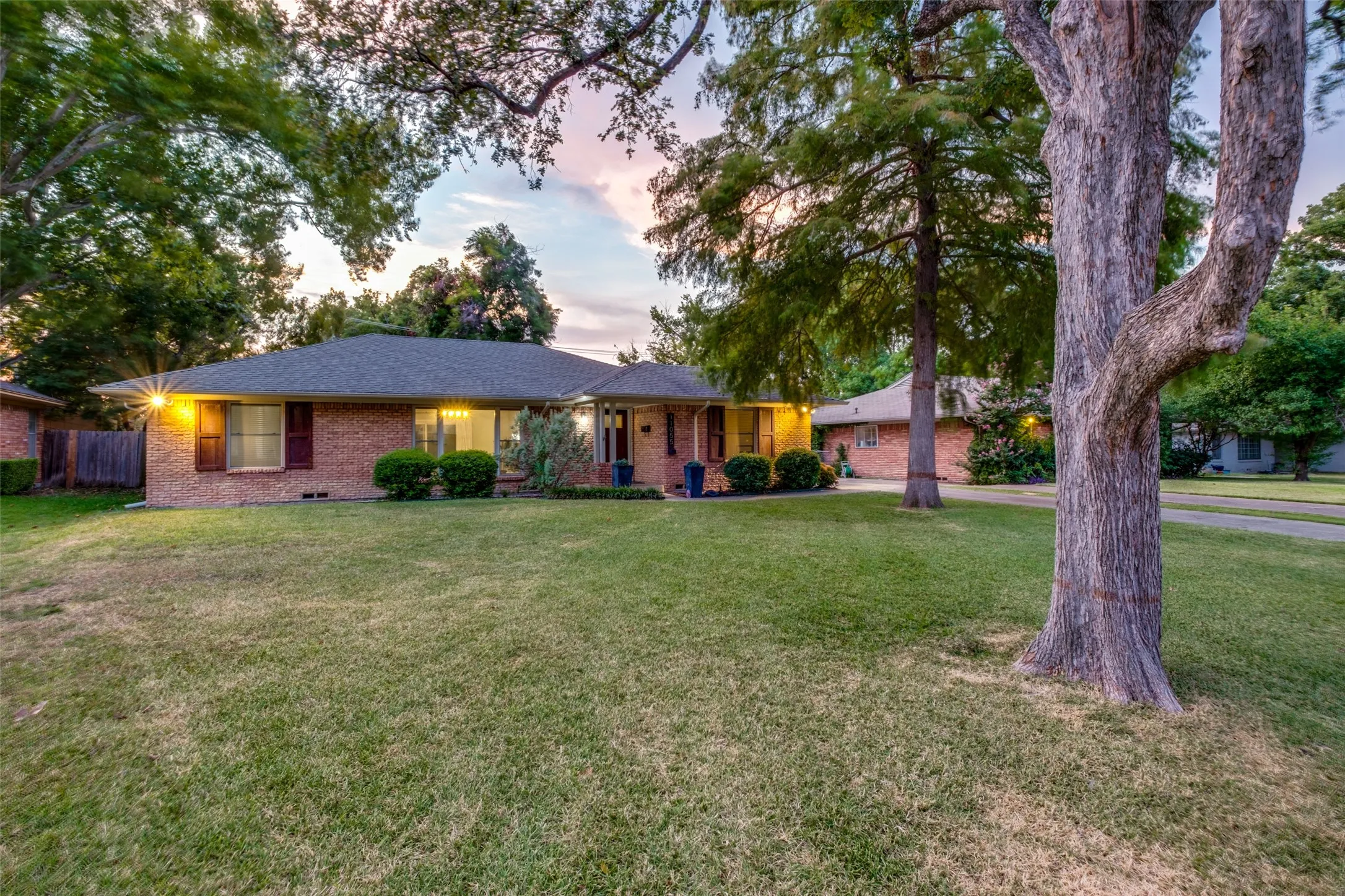Oversized front and backyard with mature trees.