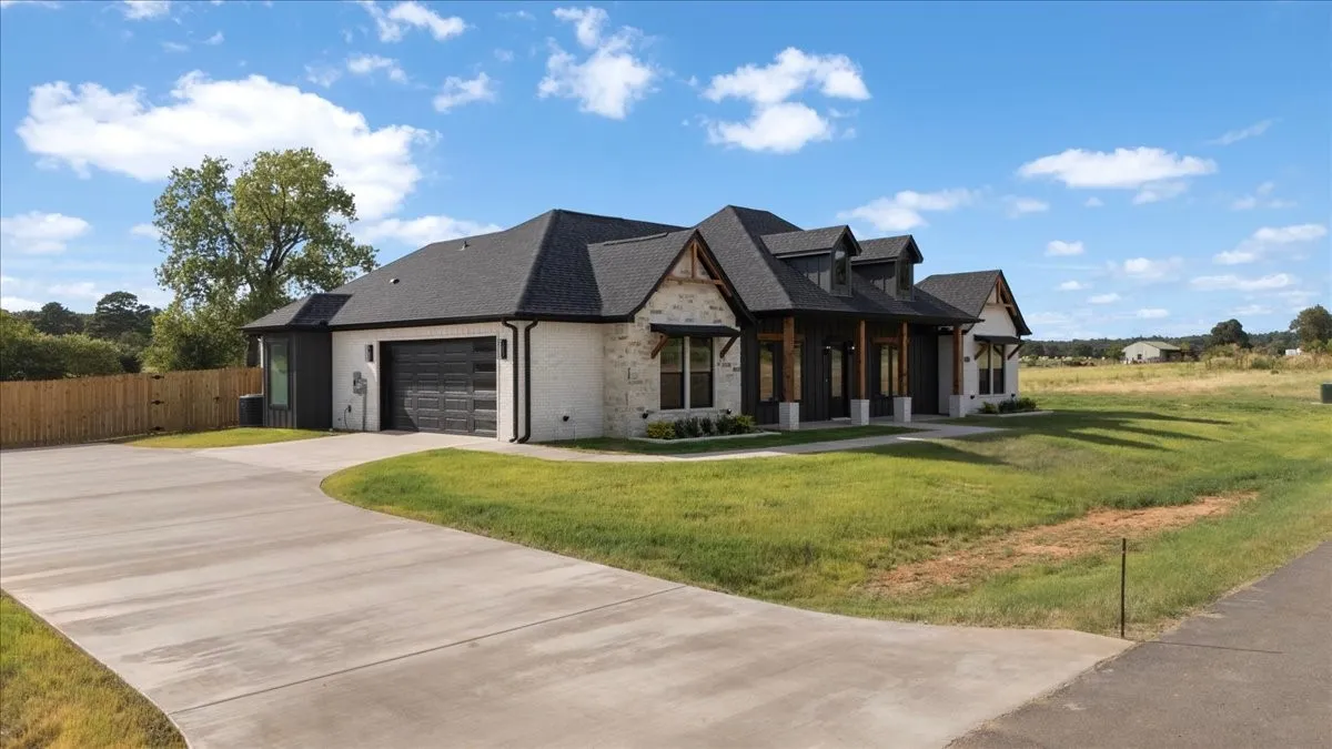 Modern architectural design featuring a distinctive peaked roofline and mixed-material exterior with stone and siding accents