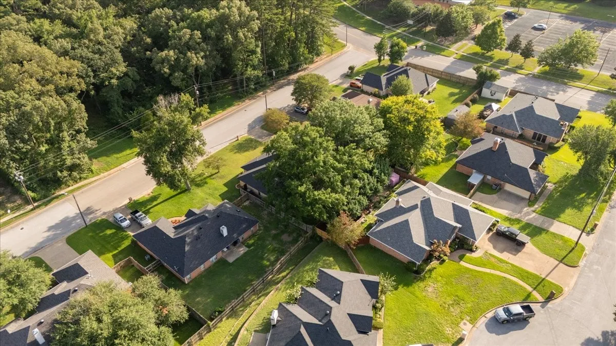 Aerial perspective showcasing a residential street with mature trees and established properties
