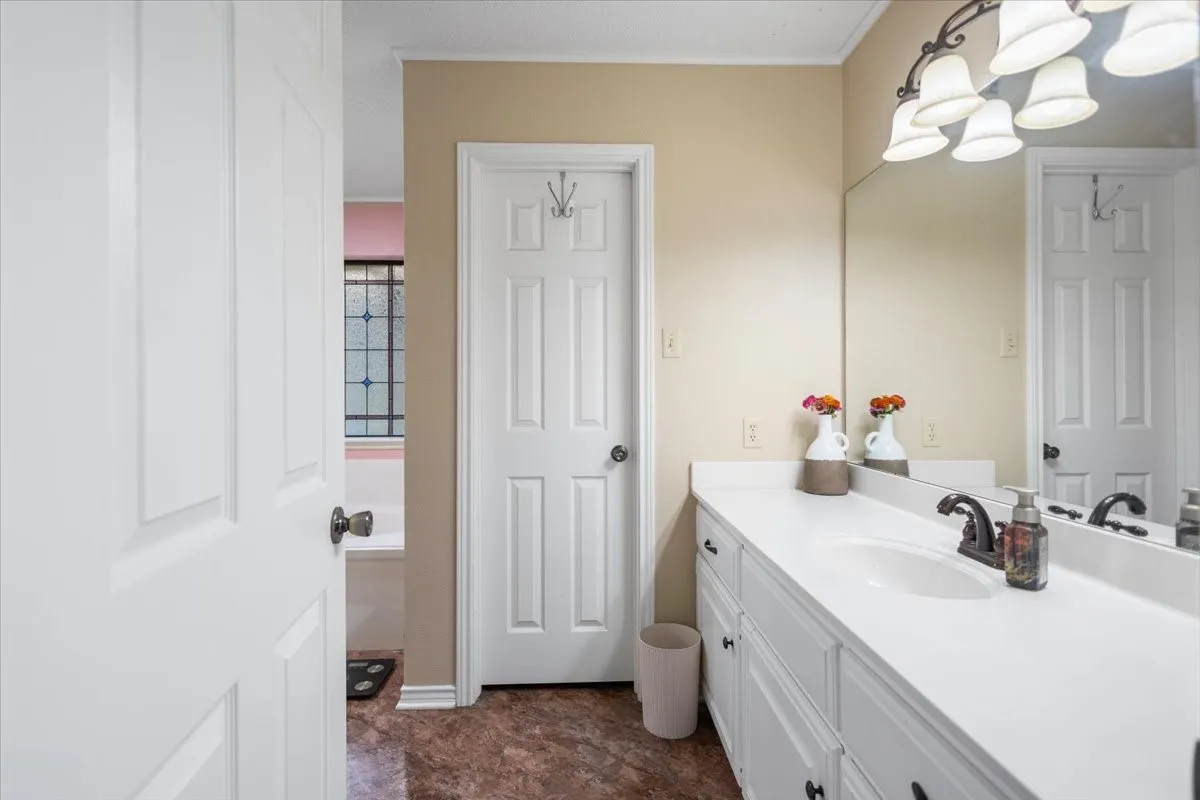 Spacious bathroom featuring a single vanity with an integrated sink and white countertop
