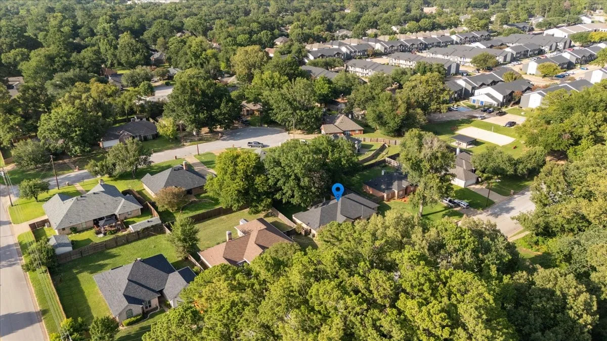 Aerial overview showcasing a residential neighborhood with numerous mature trees