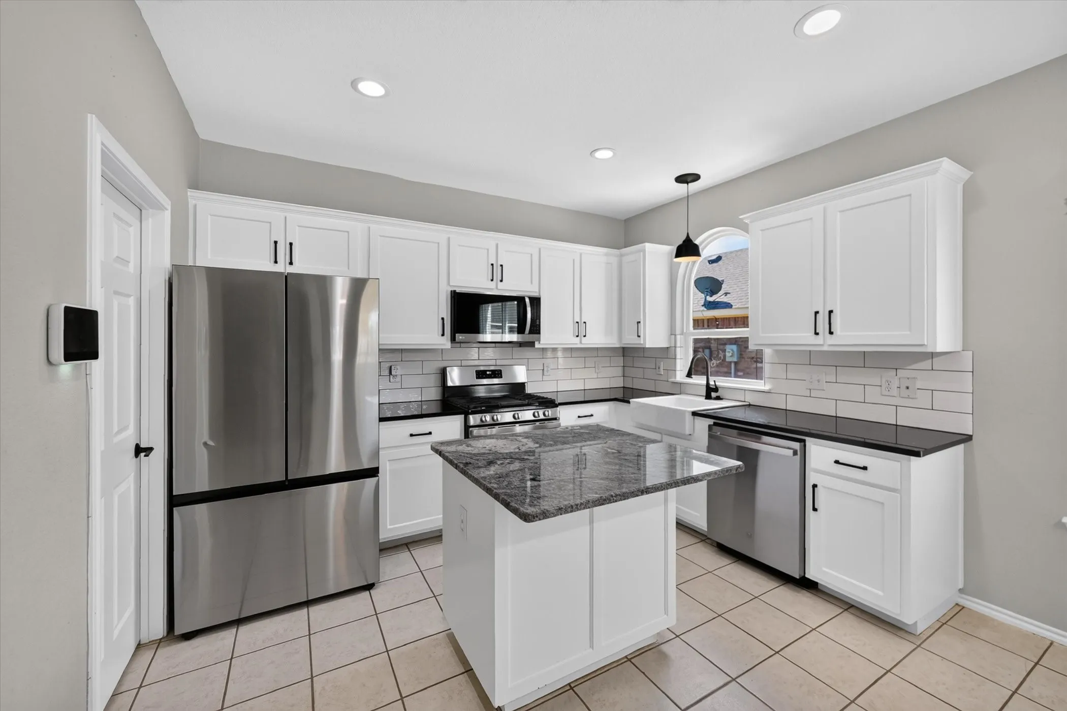 White shaker-style cabinetry with matte black hardware
