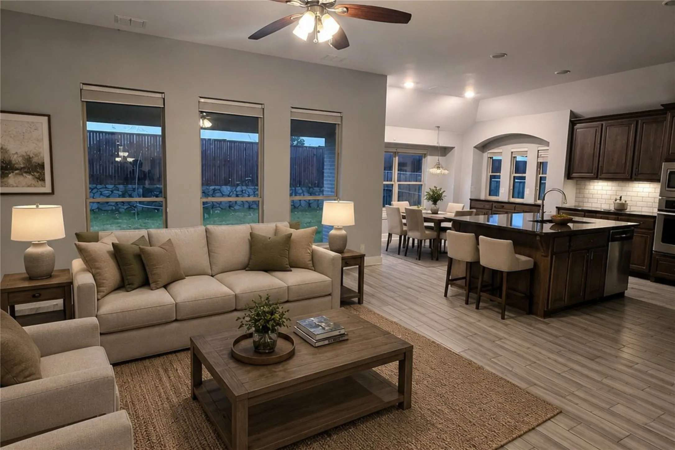 Open-concept living space featuring wood-finish flooring, recessed lighting, and a ceiling fan