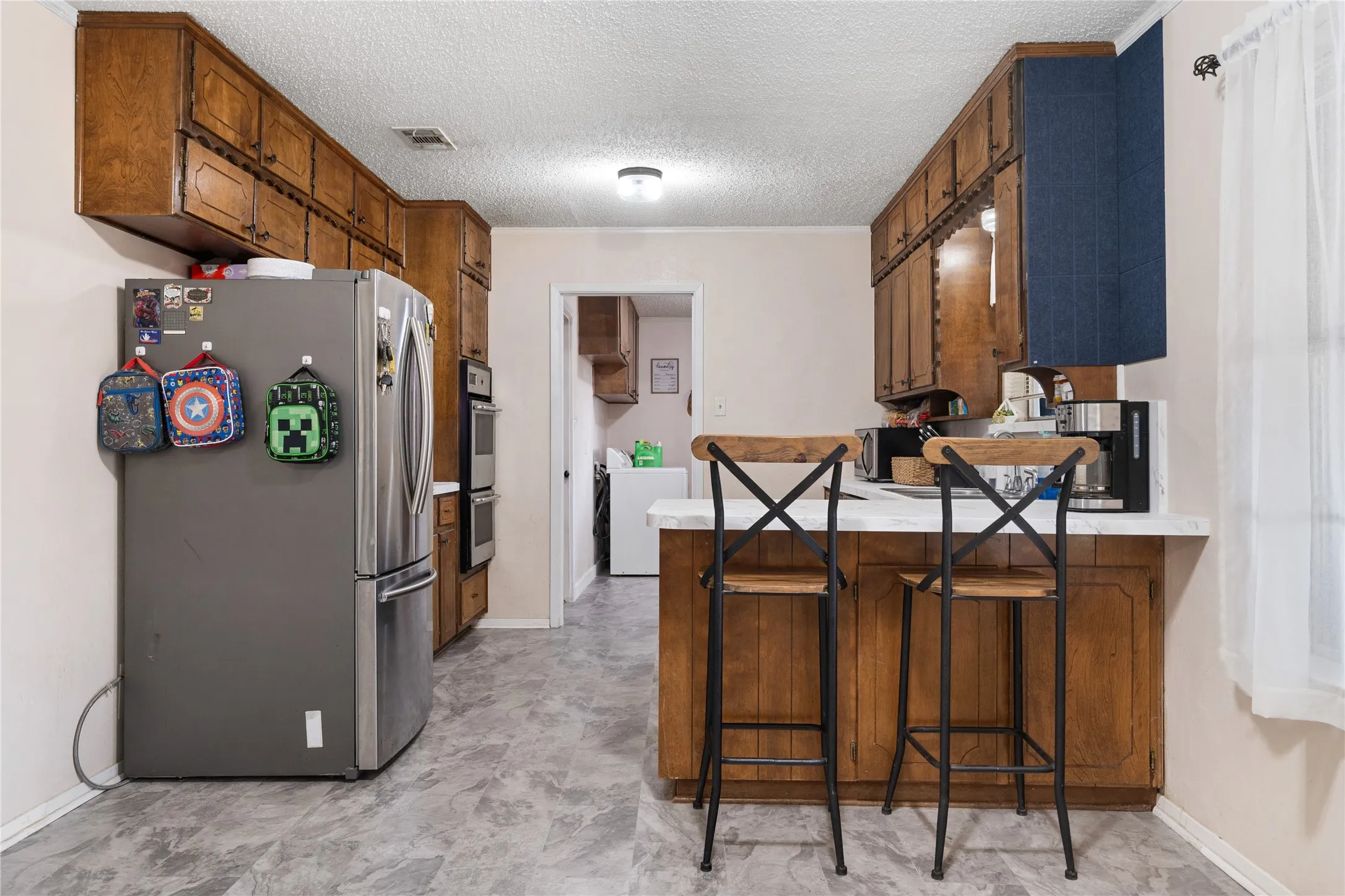 Breakfast bar separates the kitchen dining from the kitchen.