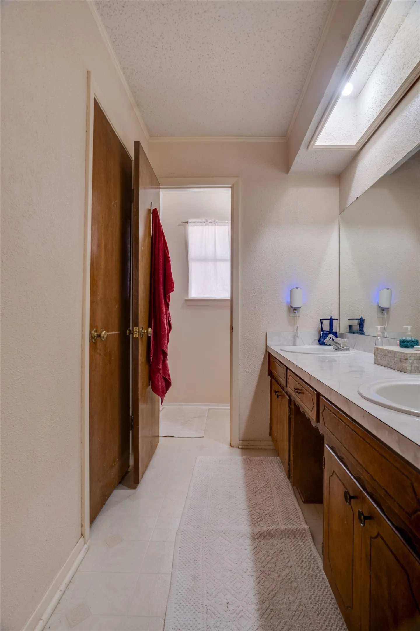 Master bath with double sink vanity and access to double 3X5 closets.