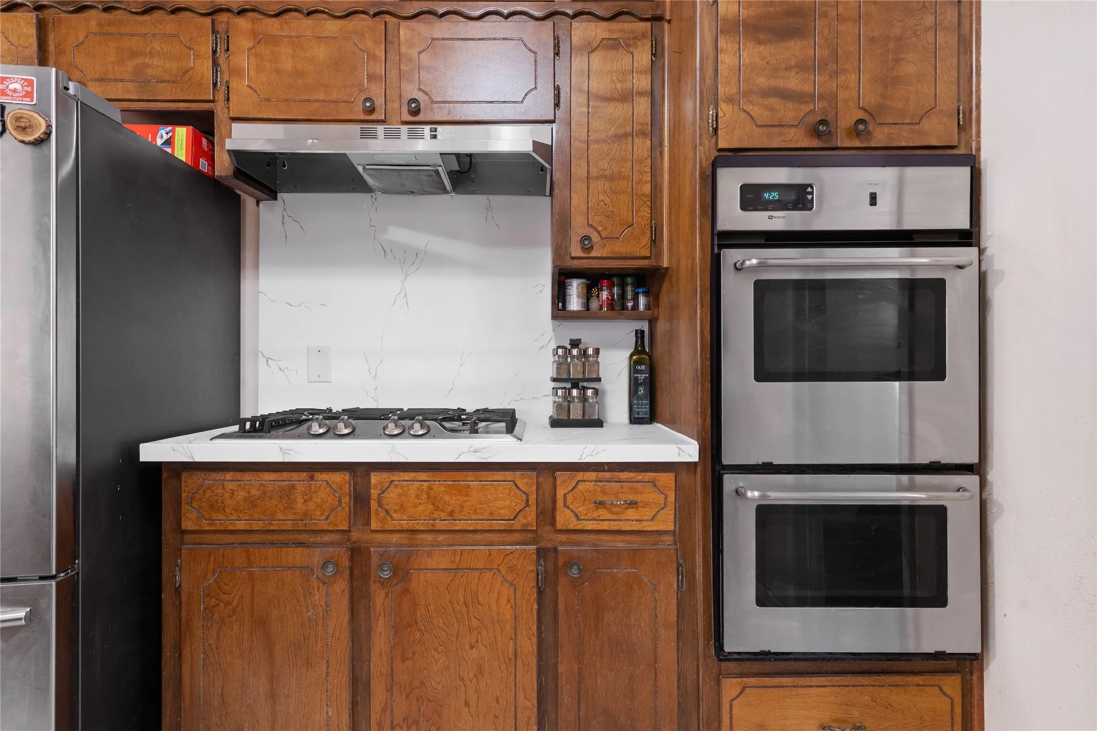 Newer appliances includes a double oven and gas cooktop.