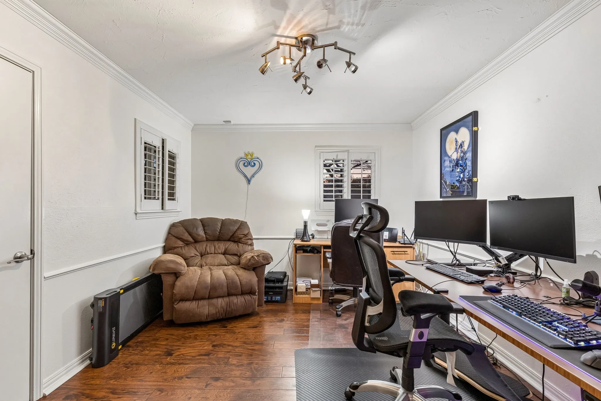 Home office with dark wood-style flooring and ornamental molding