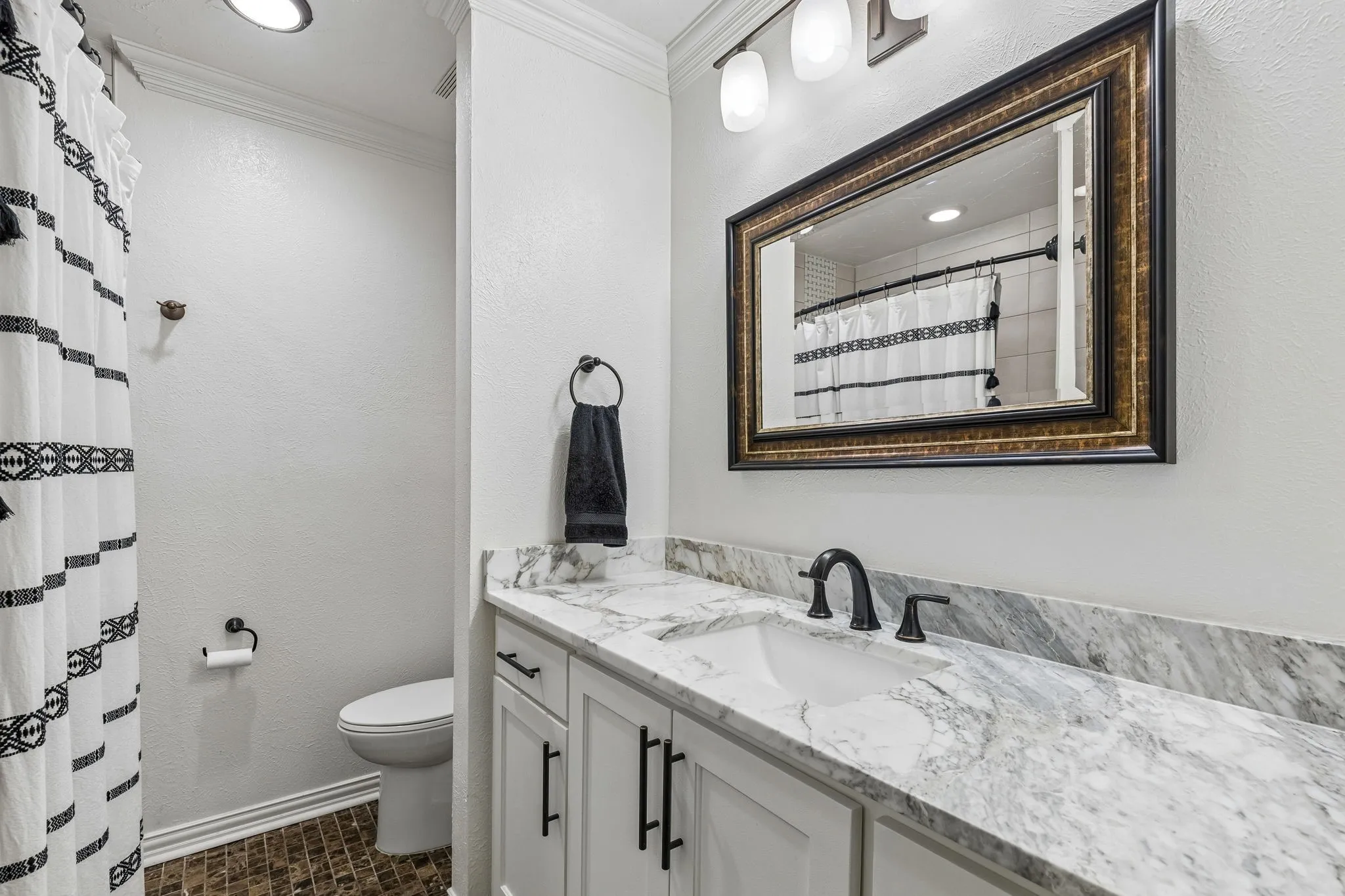 Bathroom featuring vanity, a shower with curtain, crown molding, recessed lighting, and a textured wall