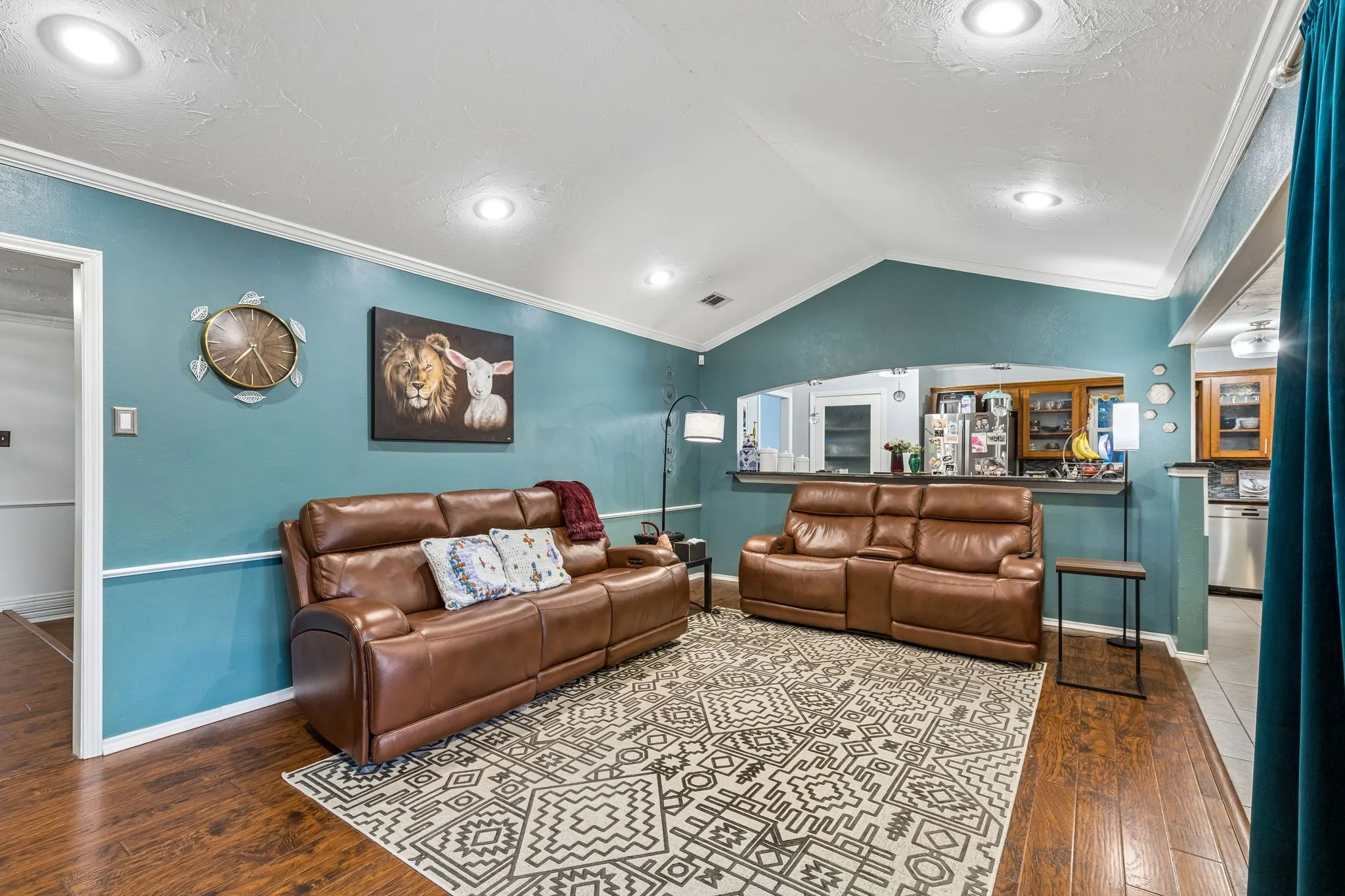 Living area featuring crown molding and dark wood-style flooring