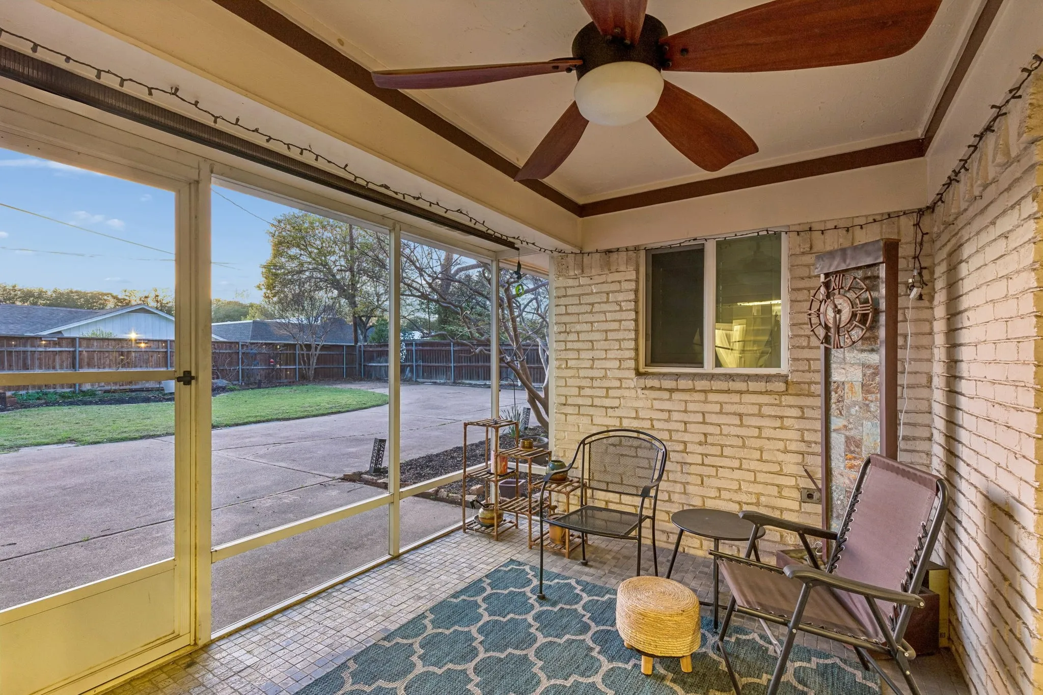 Sunroom featuring a ceiling fan and a patio area