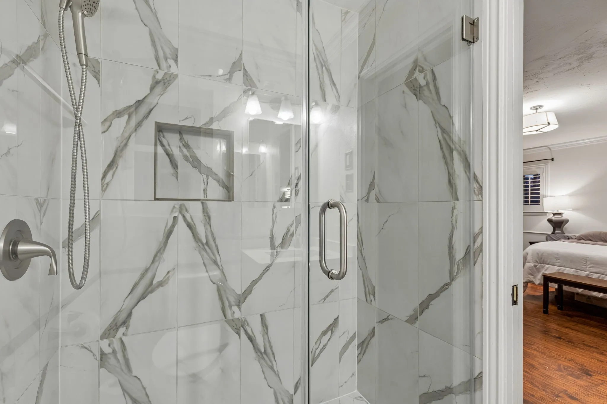 Full bathroom featuring ensuite bath and a marble finish shower