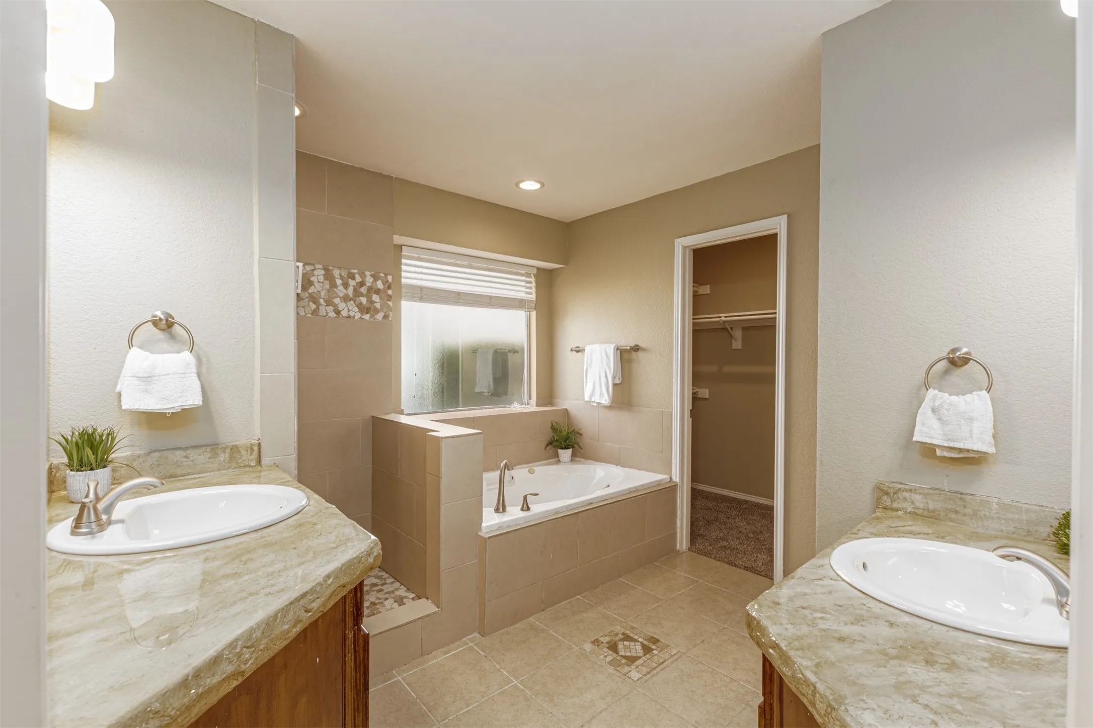 Primary en-suite full bath with separate shower and tub. Dual Vanities