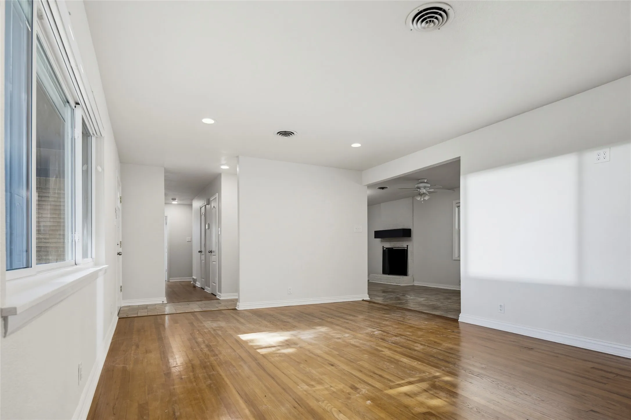 Hallway to bedrooms and opening to secondary living and kitchen