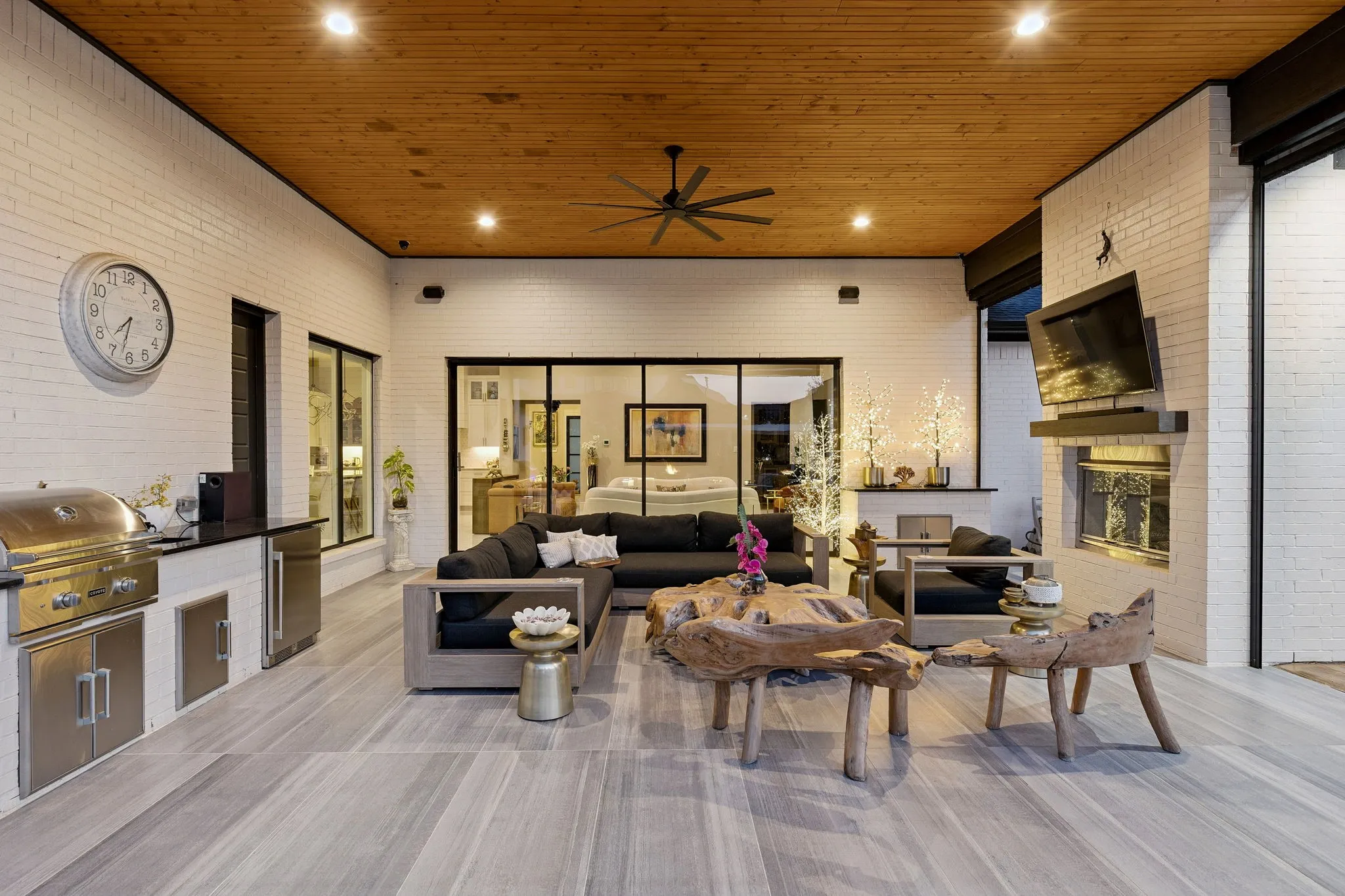Outside, the covered patio, pool, 8-person spa, and backyard environment have been thoughtfully curated to create visual interest, tranquility, & relaxation! The patio features electric shades, commercial size gas fireplace, Coyote grill, Zephyr frig, and prep sink, creating an ideal space for year-round entertaining.