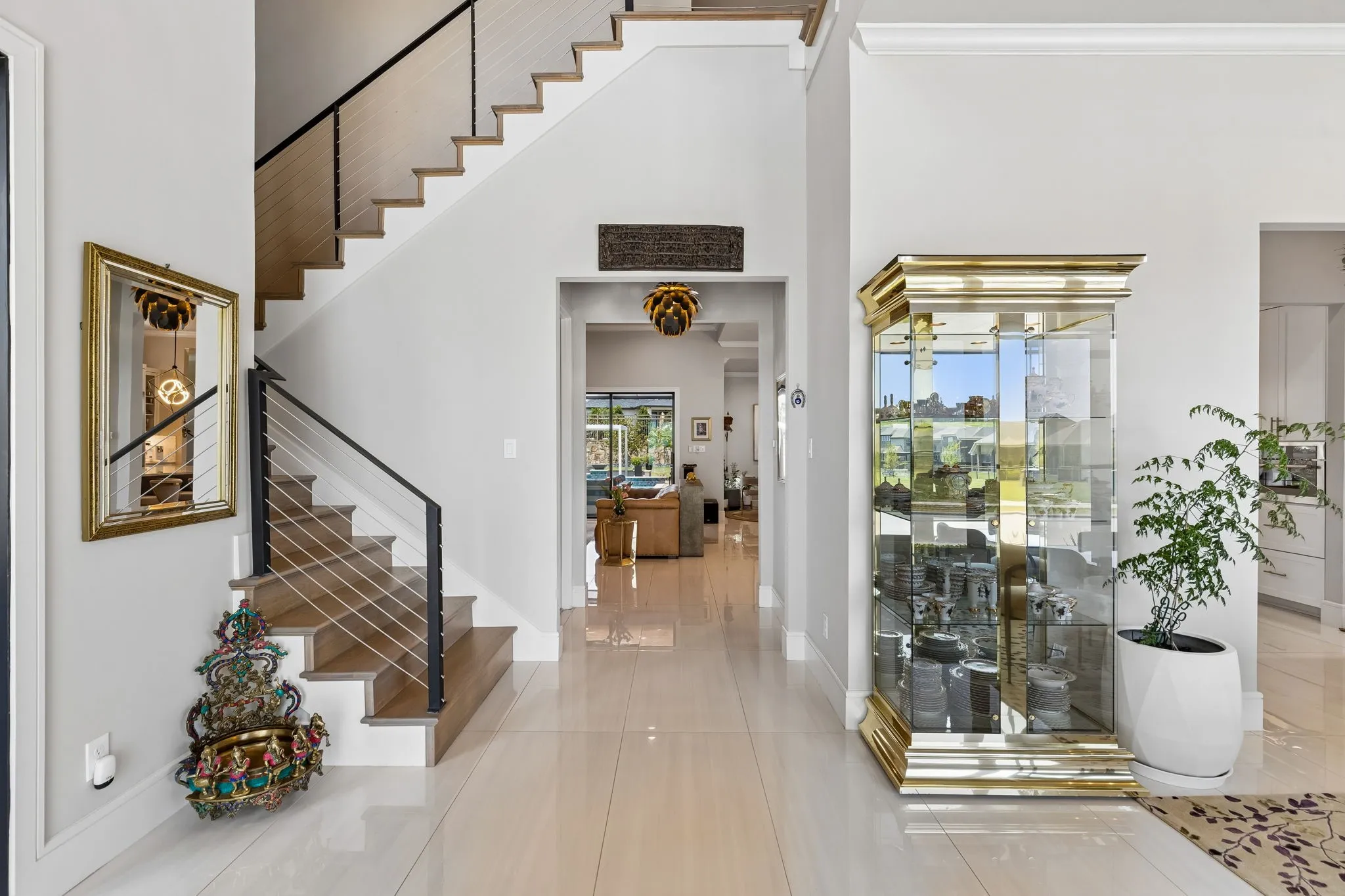 Clean architectural lines are evident upon entry where picture windows, Italian porcelain tile, museum finish walls, designer light fixtures, and soaring ceilings elevate the space.