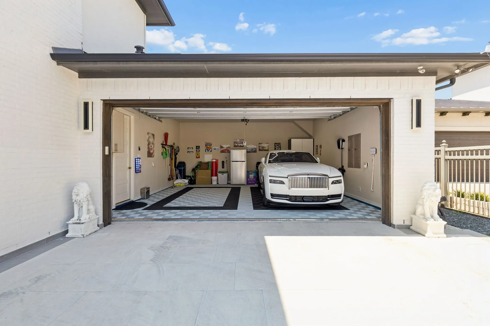 Highly-desired 3 car porte-cochere design with large scale tile pavers; Rolls-Royce EV charger in the 2 car garage and another EV charger in the single car garage; insulated garage doors, & custom garage flooring; electric gate.