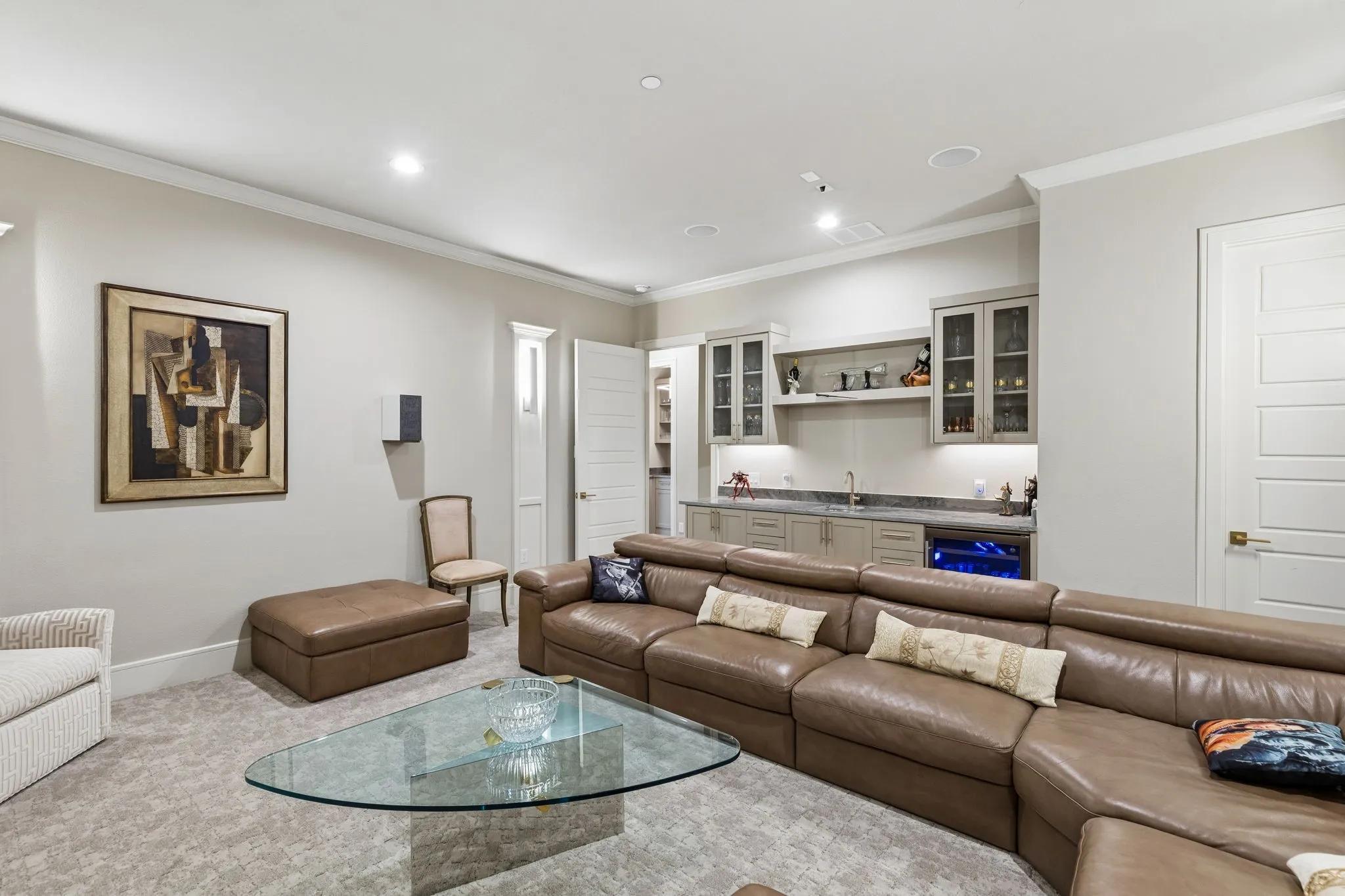 Downstairs media room with 7.1 surround sound and wet bar provides even more entertaining space.
