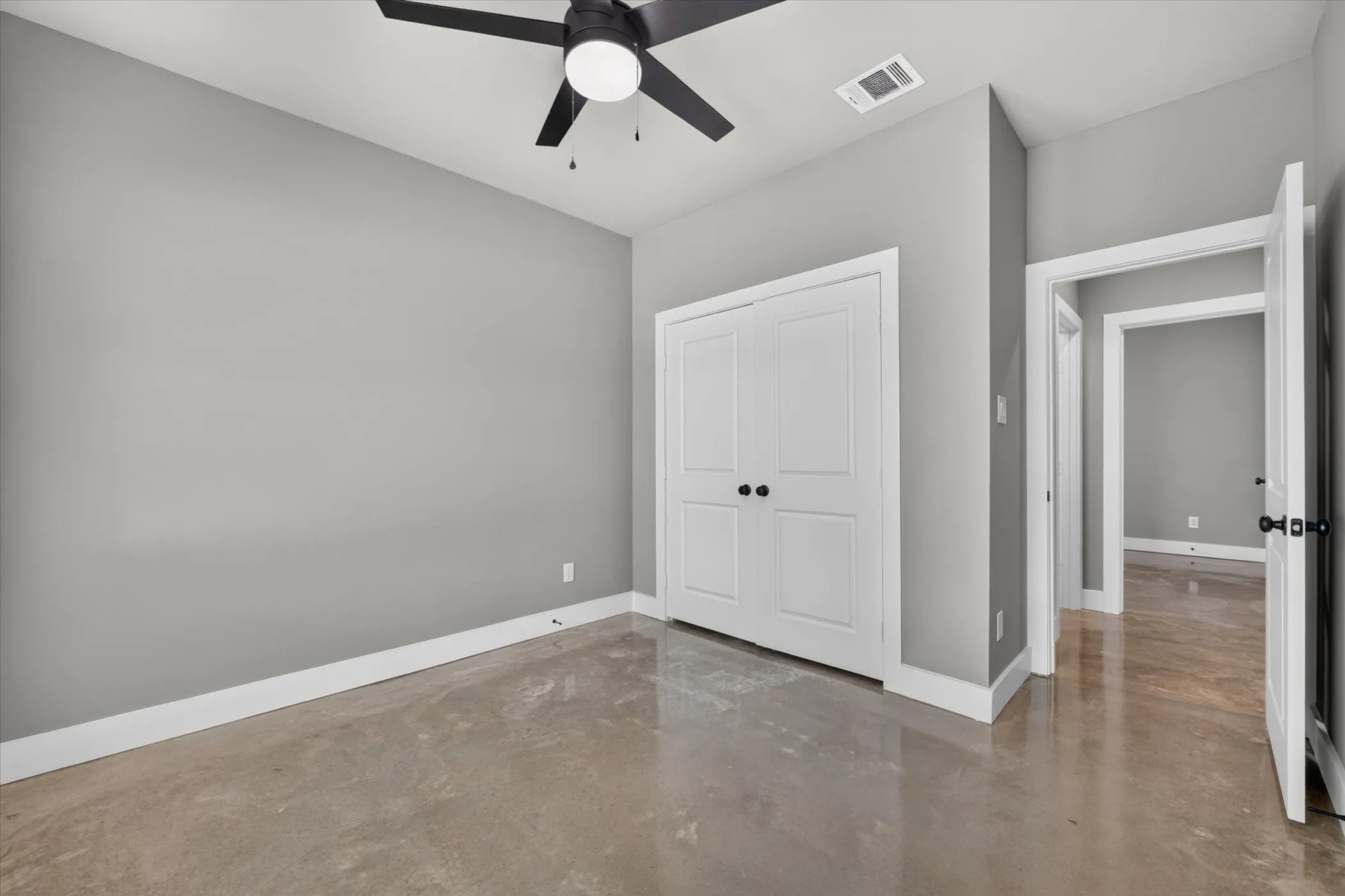 View from front bedroom showing closet and hall to bathroom and middle bedroom.