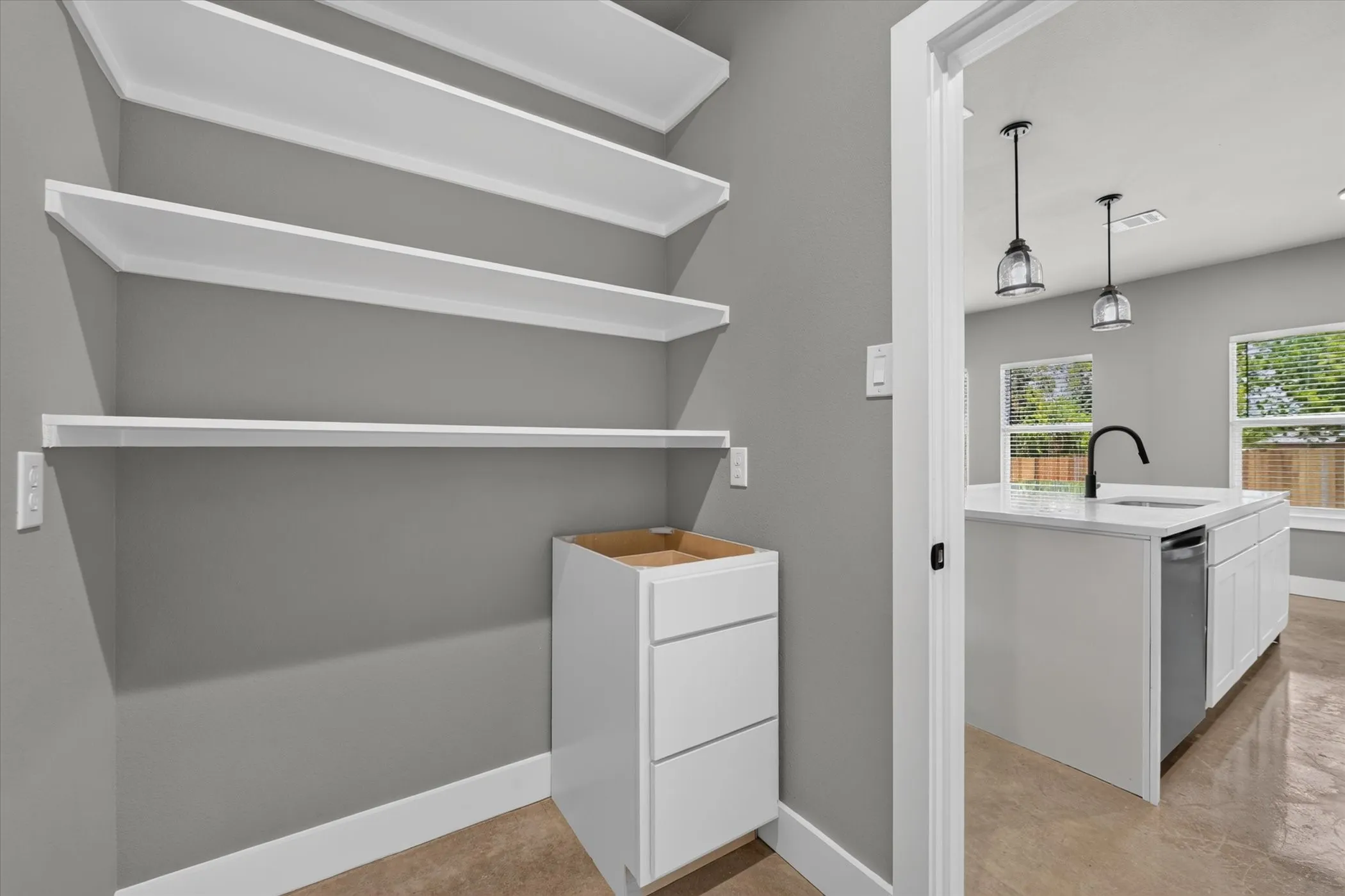 Utility room includes pantry shelving.