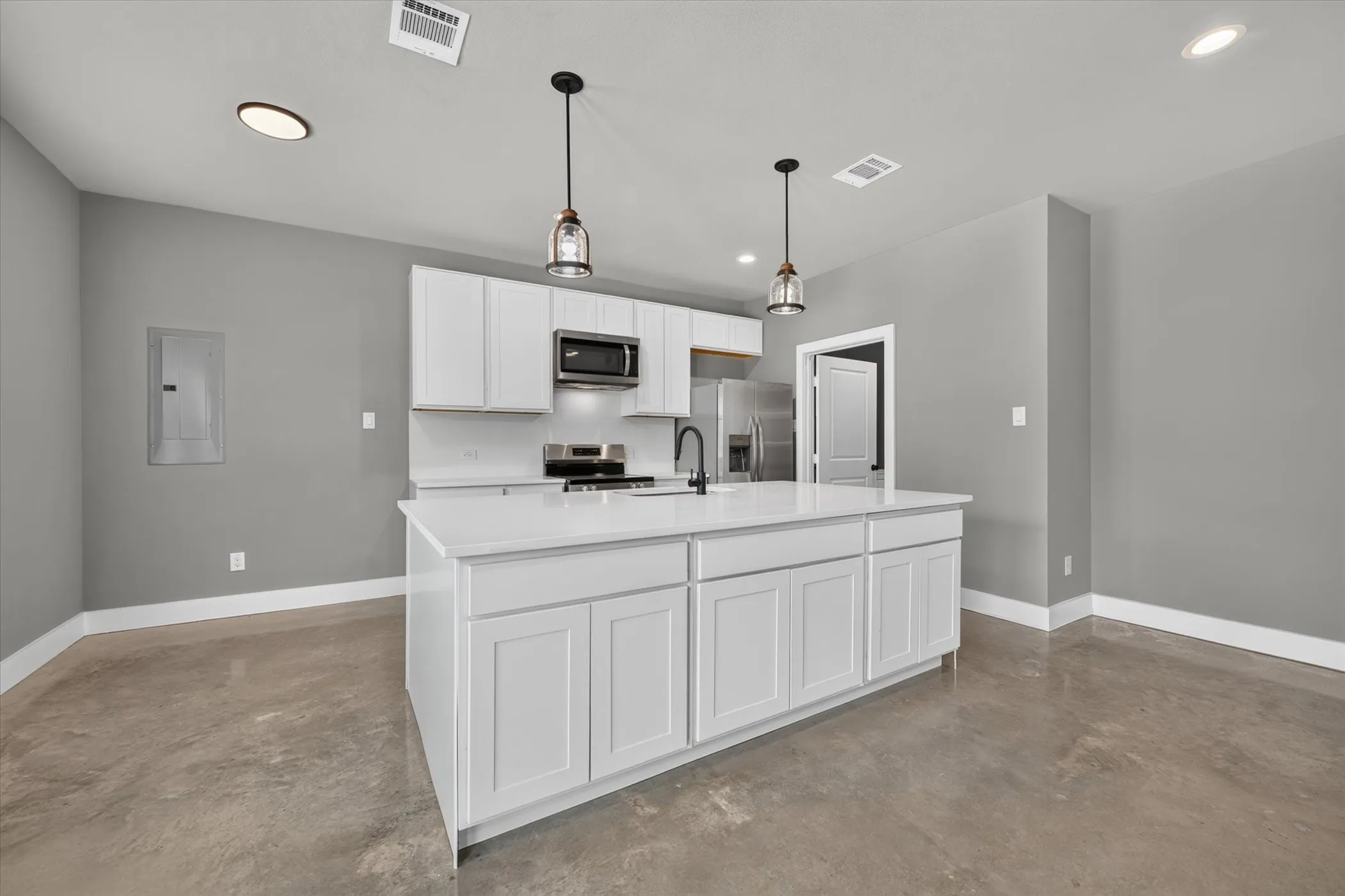 Large kitchen island with abundance of storage drawers and cabinets.