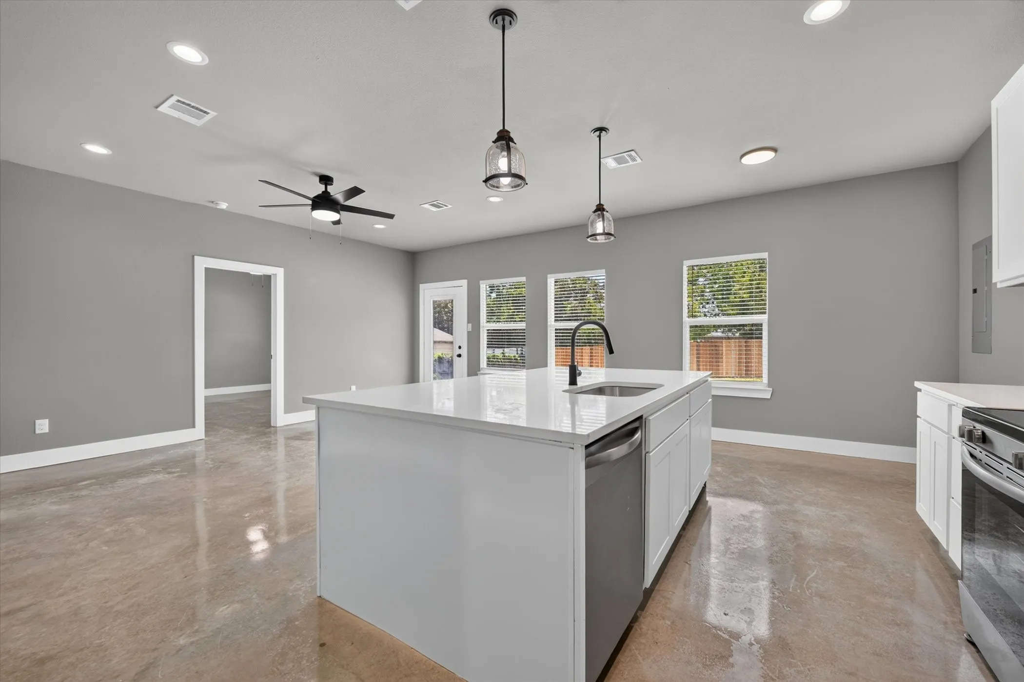 Back windows and glass door allow for natural light to flood the home.
