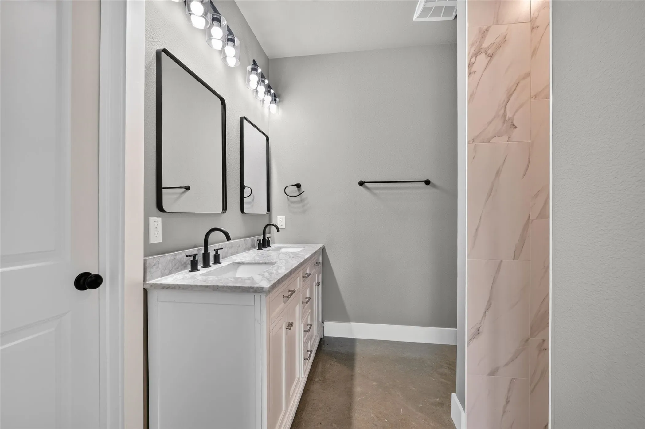 Primary bathroom features double vanity, walk-in shower and walk-in closet.