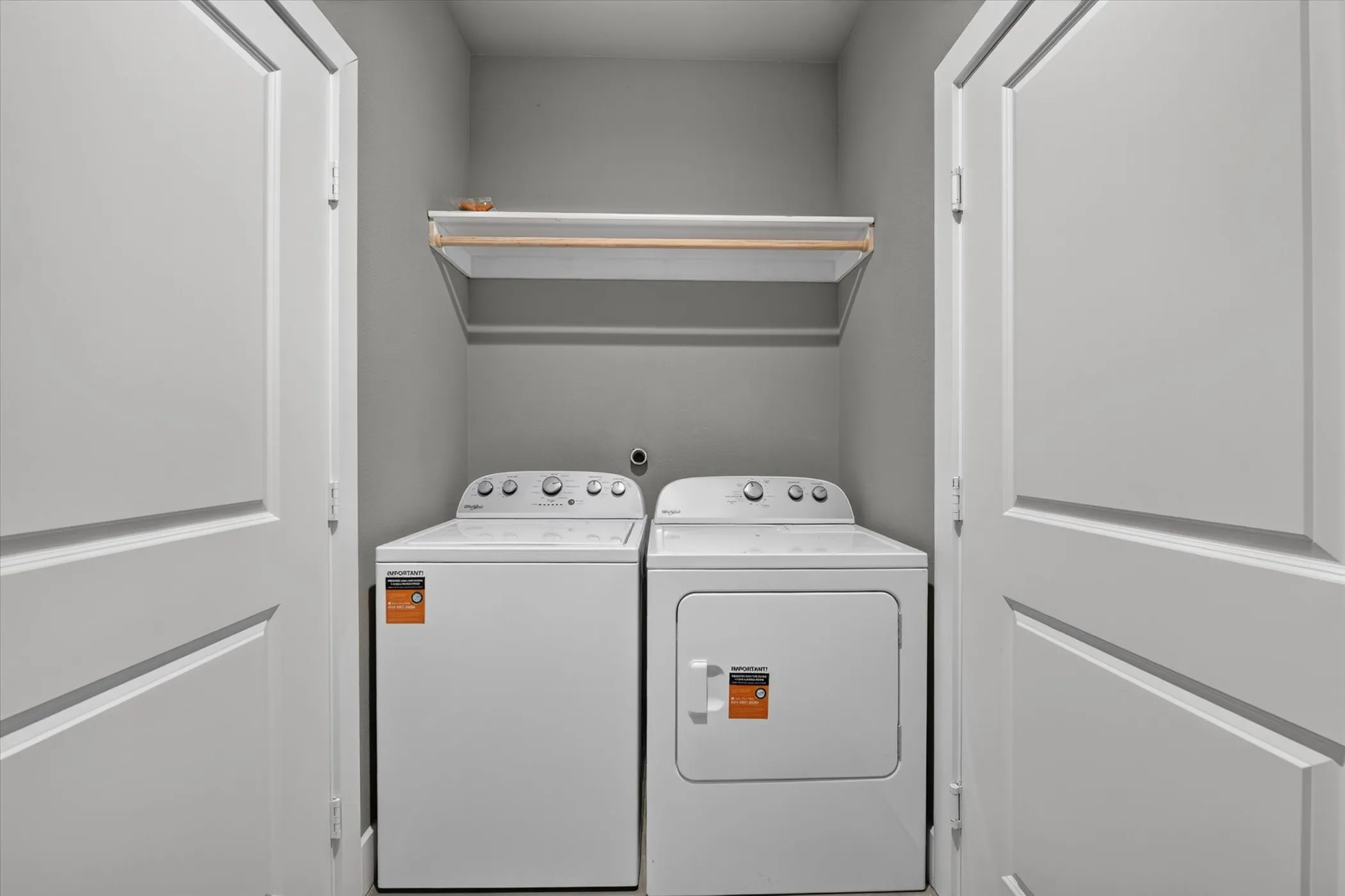 Laundry room includes new washer dryer.