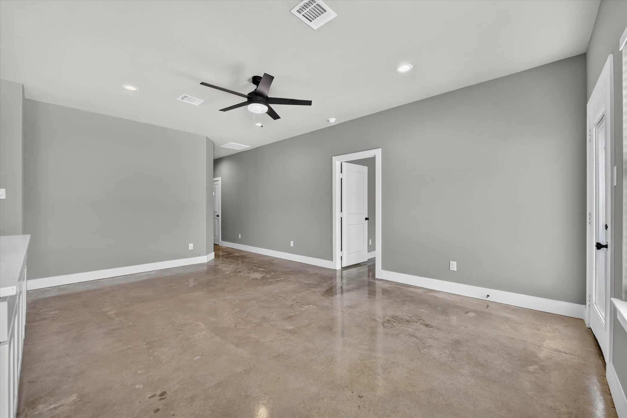 Living room with door to primary bedroom