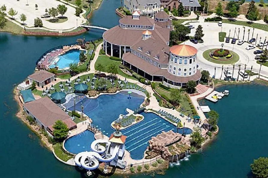 Expansive Savannah Town Community complex with water-front recreation featuring tennis courts, multiple pools, a water slide, and a community center.