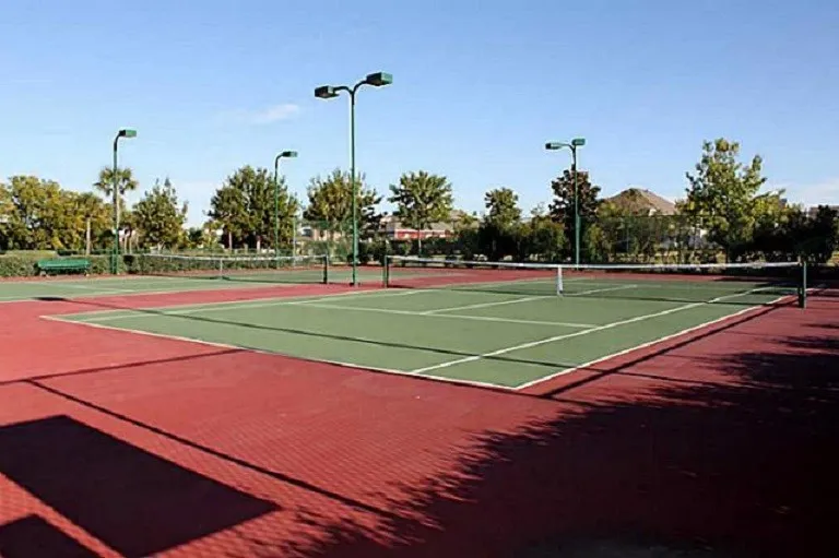 Expansive Savannah Town Community complex with water-front recreation featuring tennis courts, multiple pools, a water slide, and a community center.