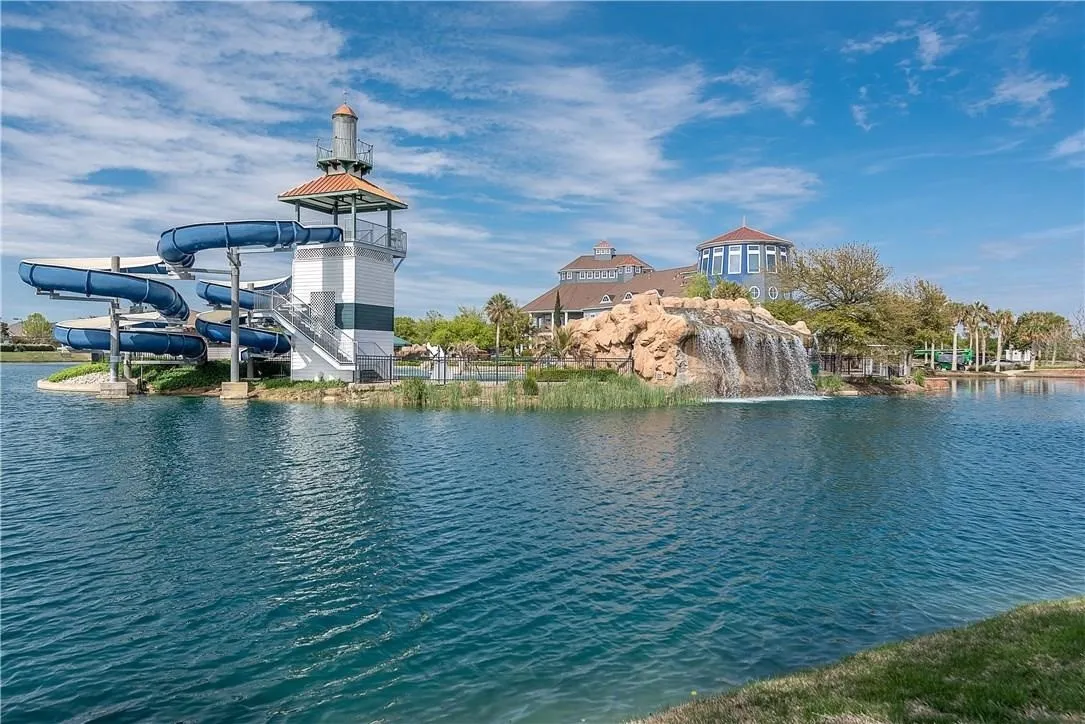 Expansive Savannah Town Community complex with water-front recreation featuring tennis courts, multiple pools, a water slide, and a community center.