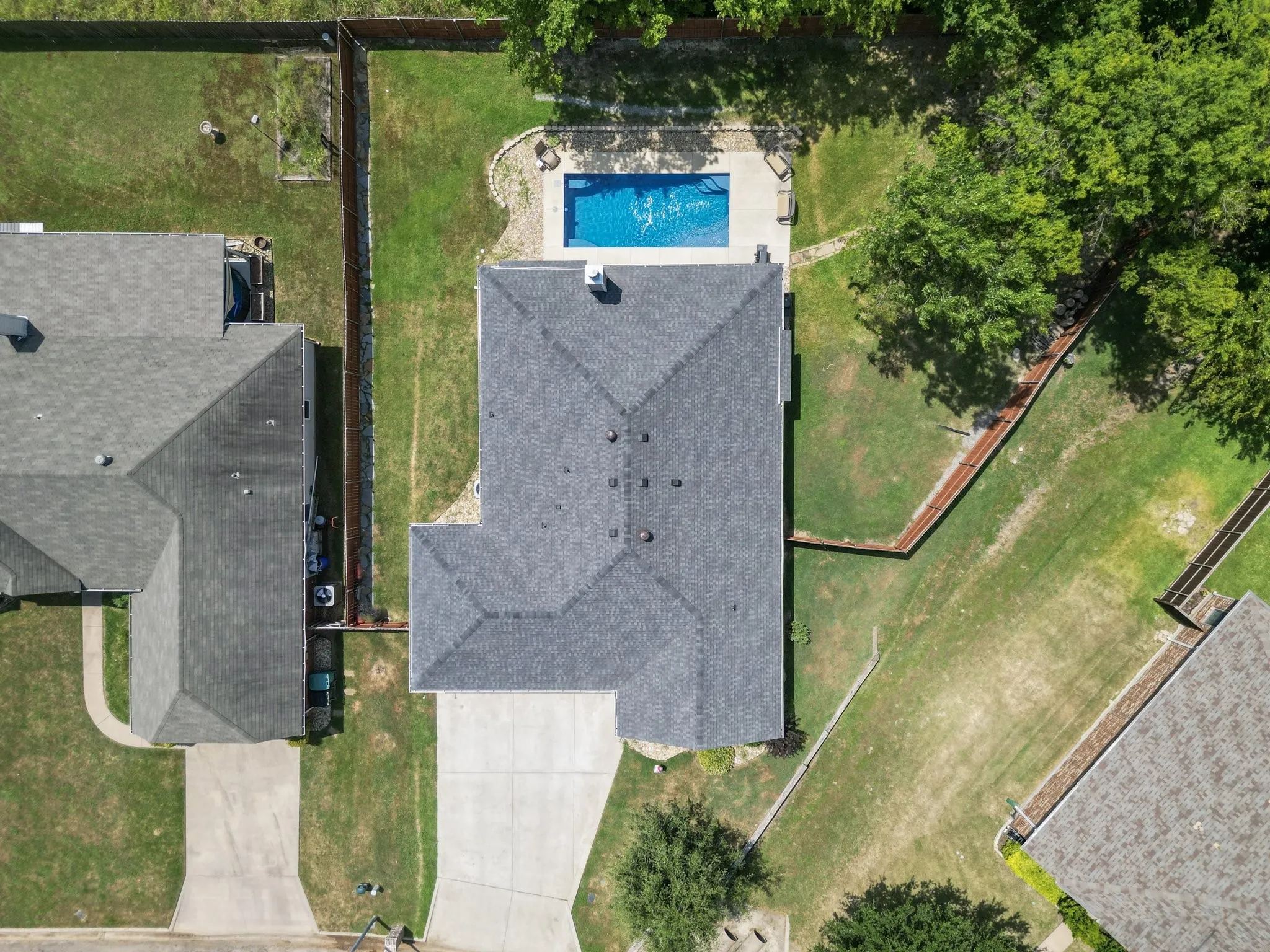 Aerial view showing the roofline, backyard pool, and spacious 0.31-acre lot.