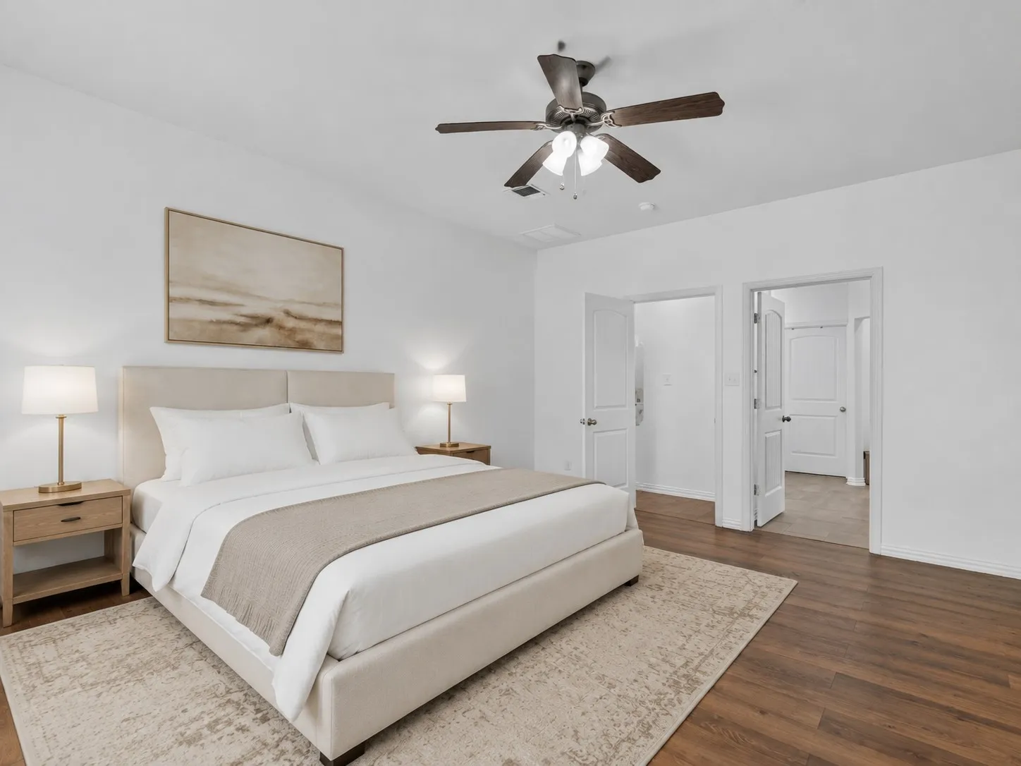 Primary suite with ceiling fan and abundant natural light, located away from the secondary bedrooms. Virtually staged.