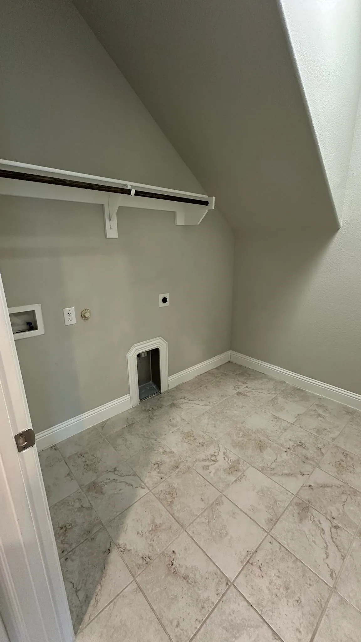 Spacious reach-in closet featuring six built-in shelves with white painted trim and soft natural lighting