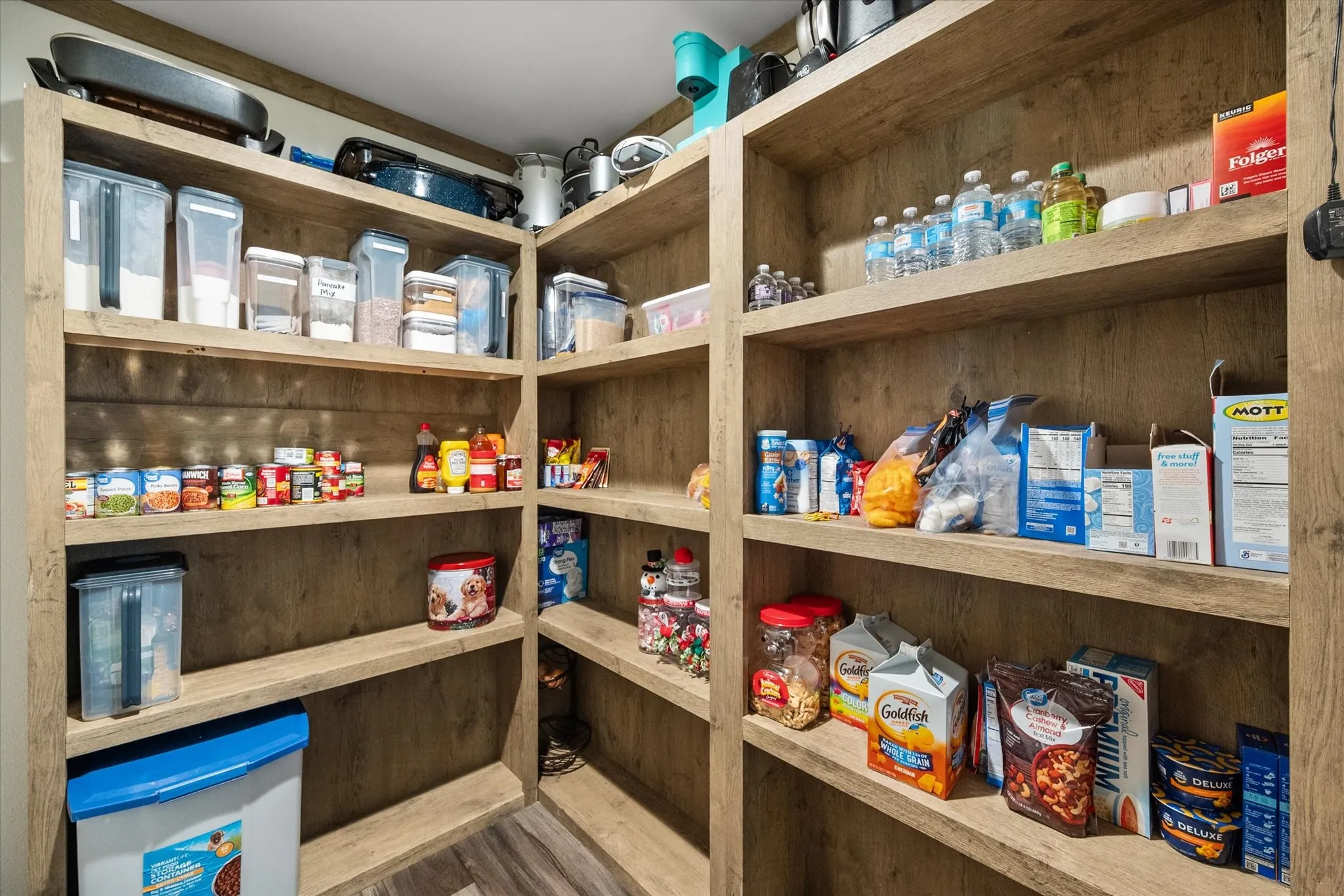 Built-in corner shelving with wood-finish construction and multiple storage tiers