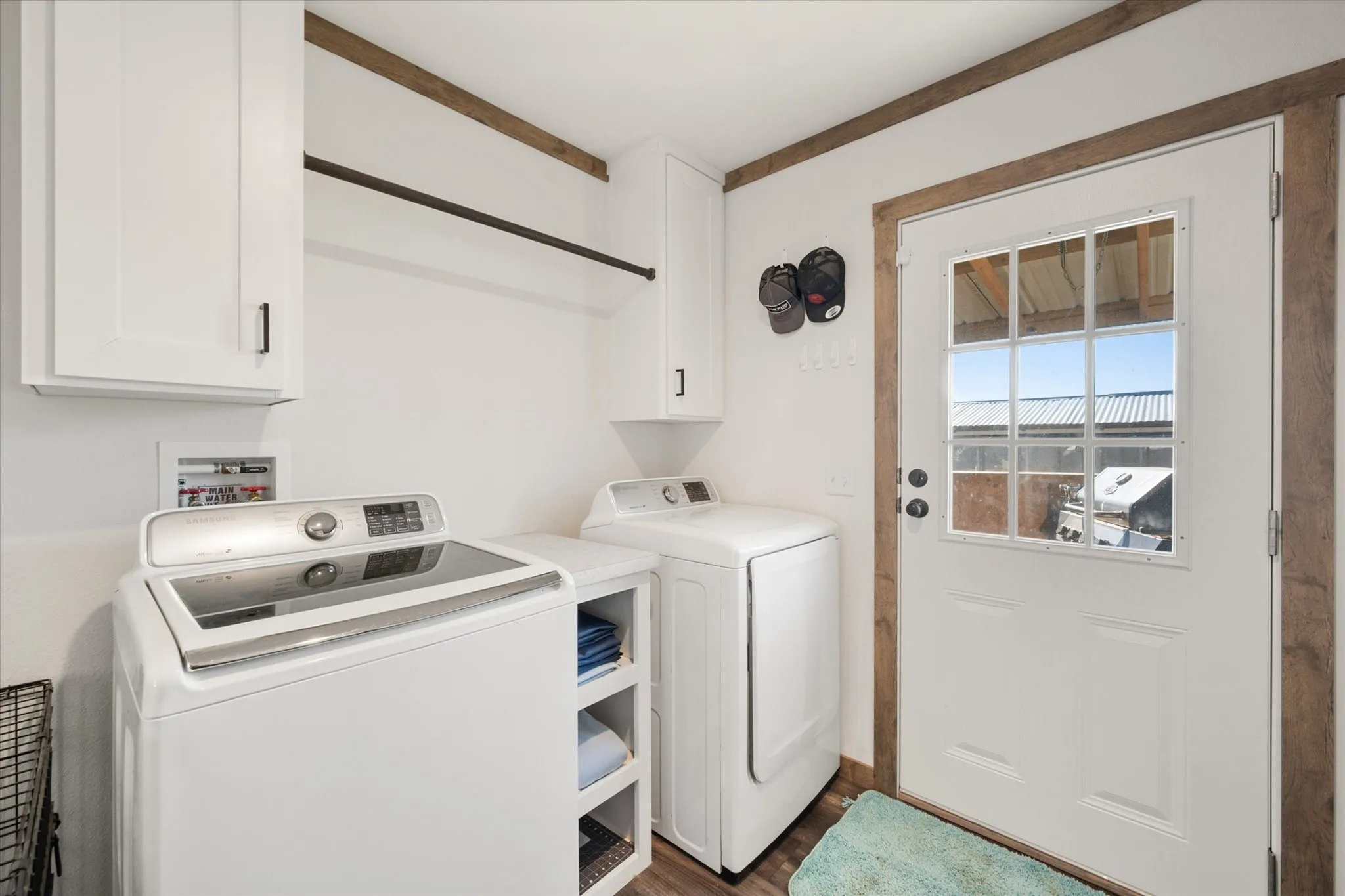 Dual vanity with white cabinetry, matte black hardware, and integrated sinks