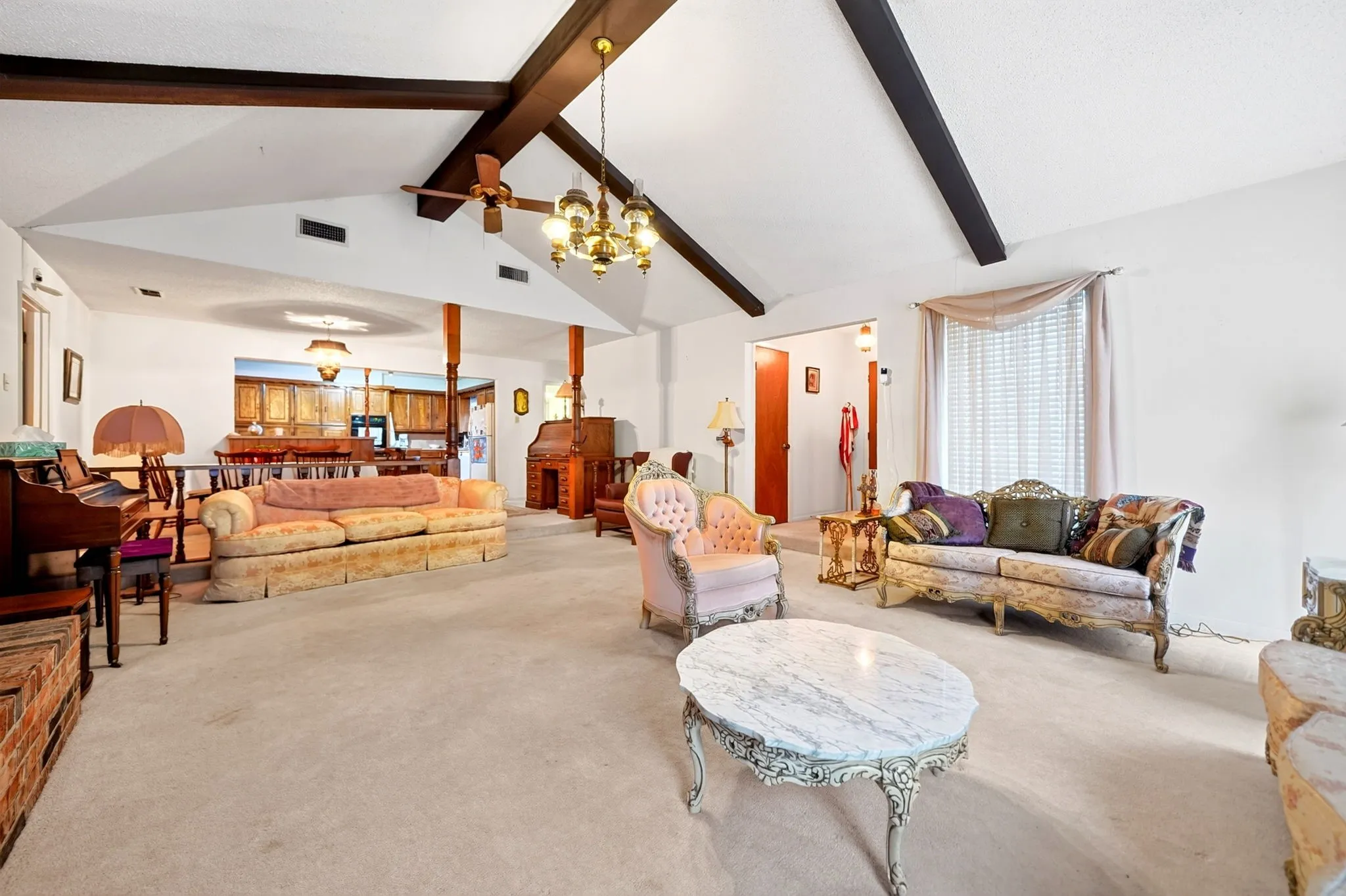 Vaulted ceiling with exposed beams, recessed lighting, and a ceiling fan