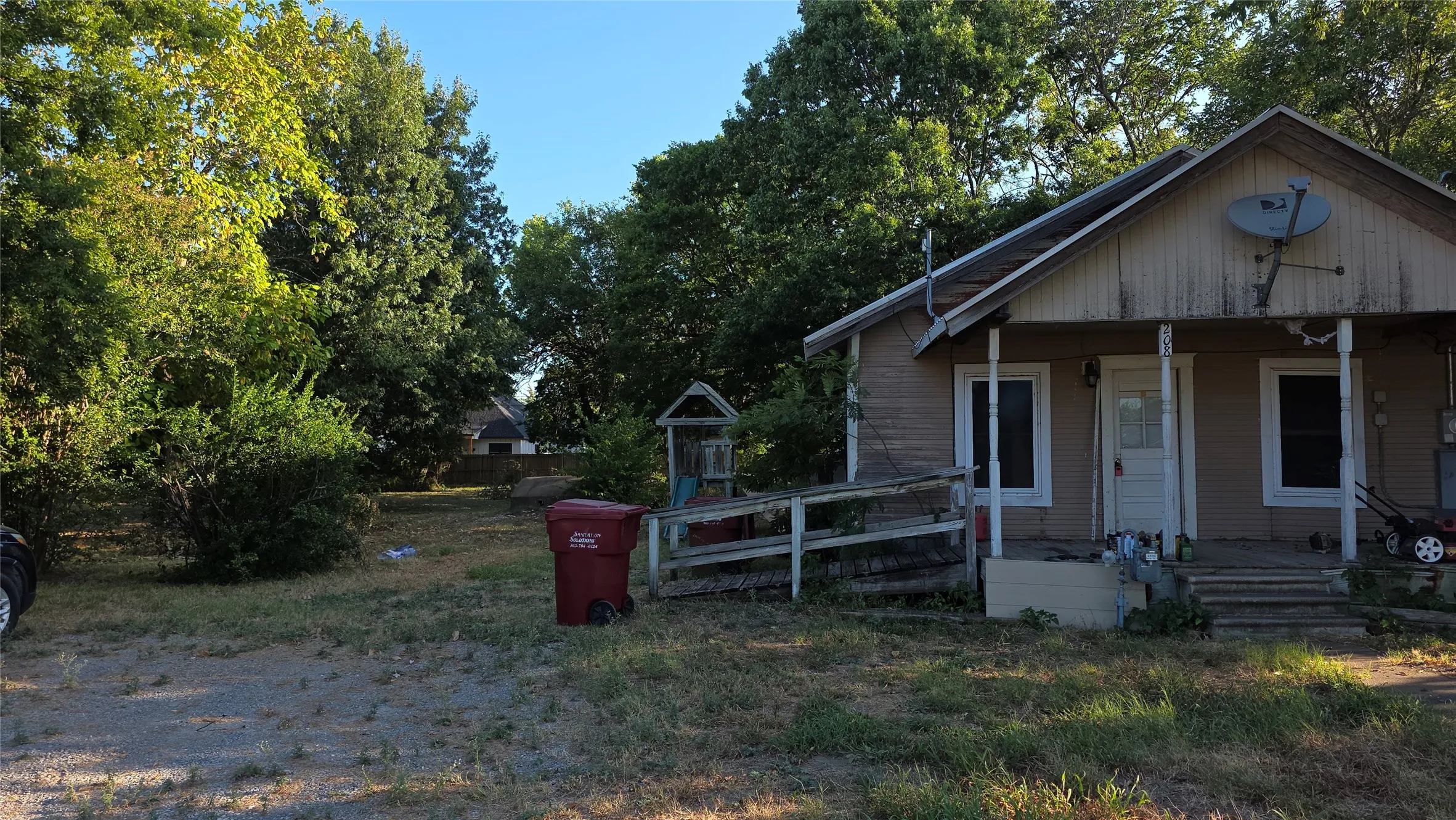 West side of house has the driveway and storm shelter