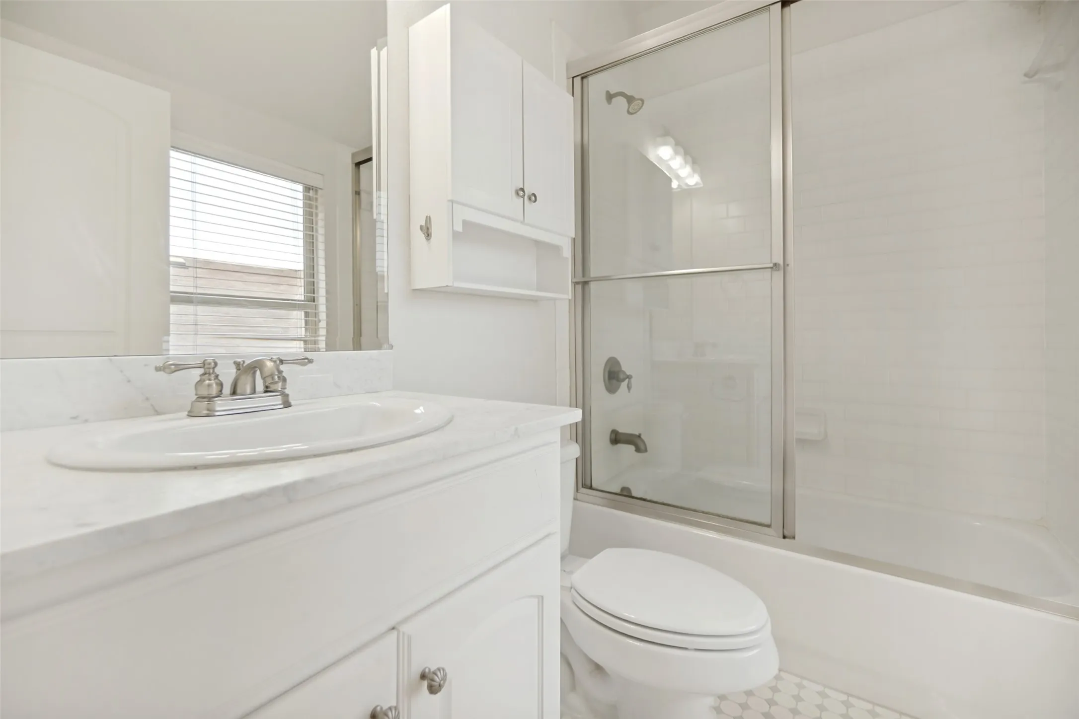 Vanity with an integrated sink and brushed nickel faucet