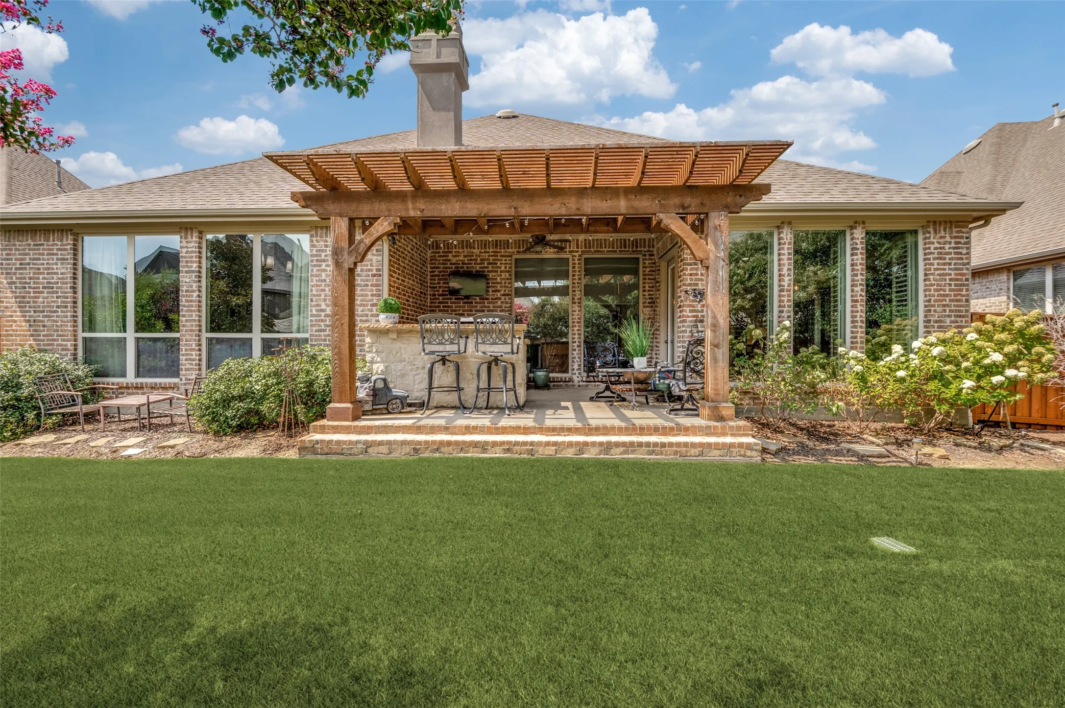 Your private backyard oasis is designed for year-round enjoyment, featuring a covered patio, custom cedar pergola, built-in outdoor kitchen with bar seating, lush landscaping, and plenty of space to relax or entertain. This beautifully finished outdoor retreat seamlessly extends your living space, making it perfect for gatherings with family and friends.