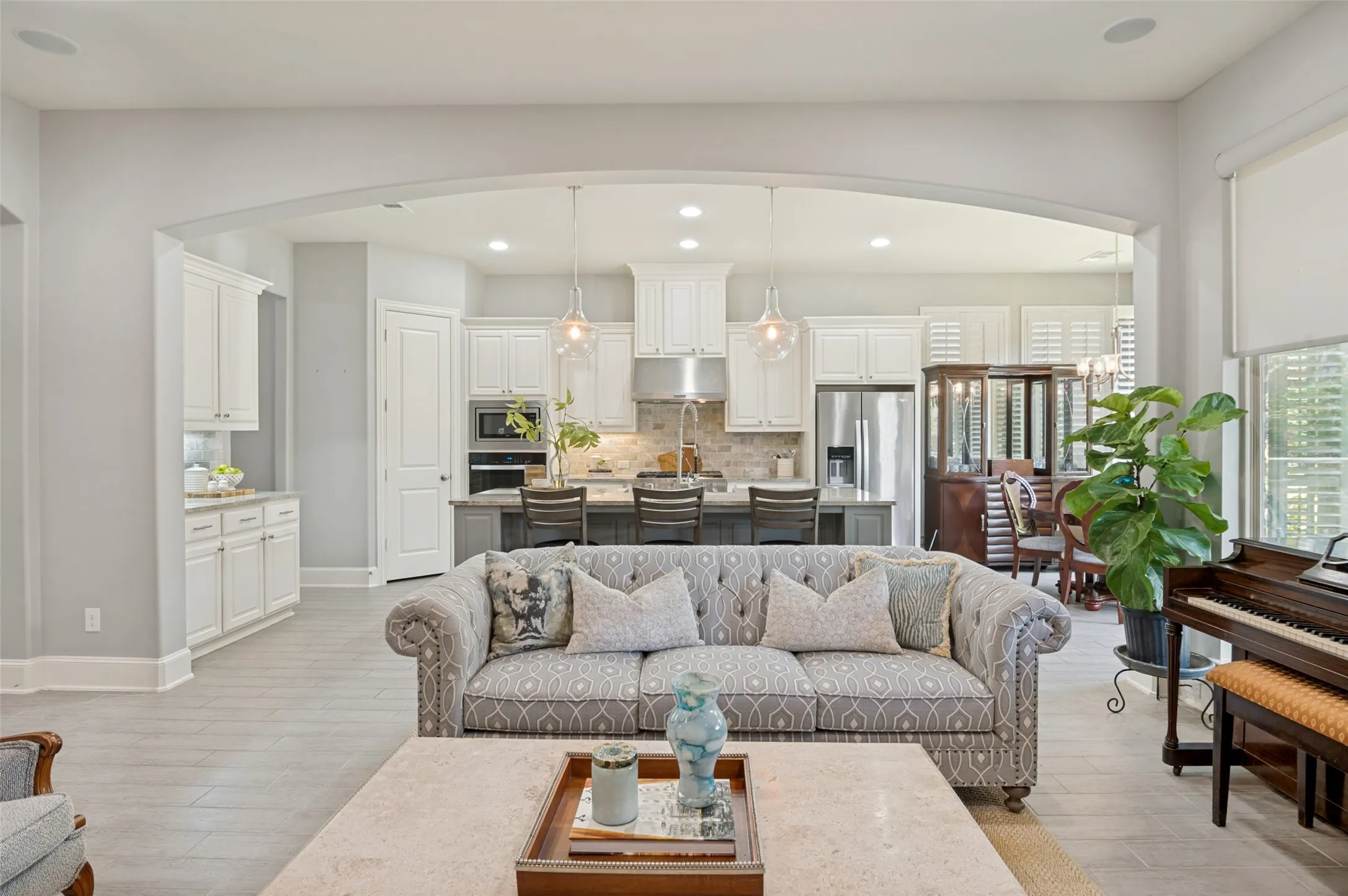 Designed for effortless entertaining, the spacious family room flows seamlessly into the chef's kitchen and breakfast room, creating an inviting open-concept layout filled with natural light and views of the beautifully landscaped backyard.