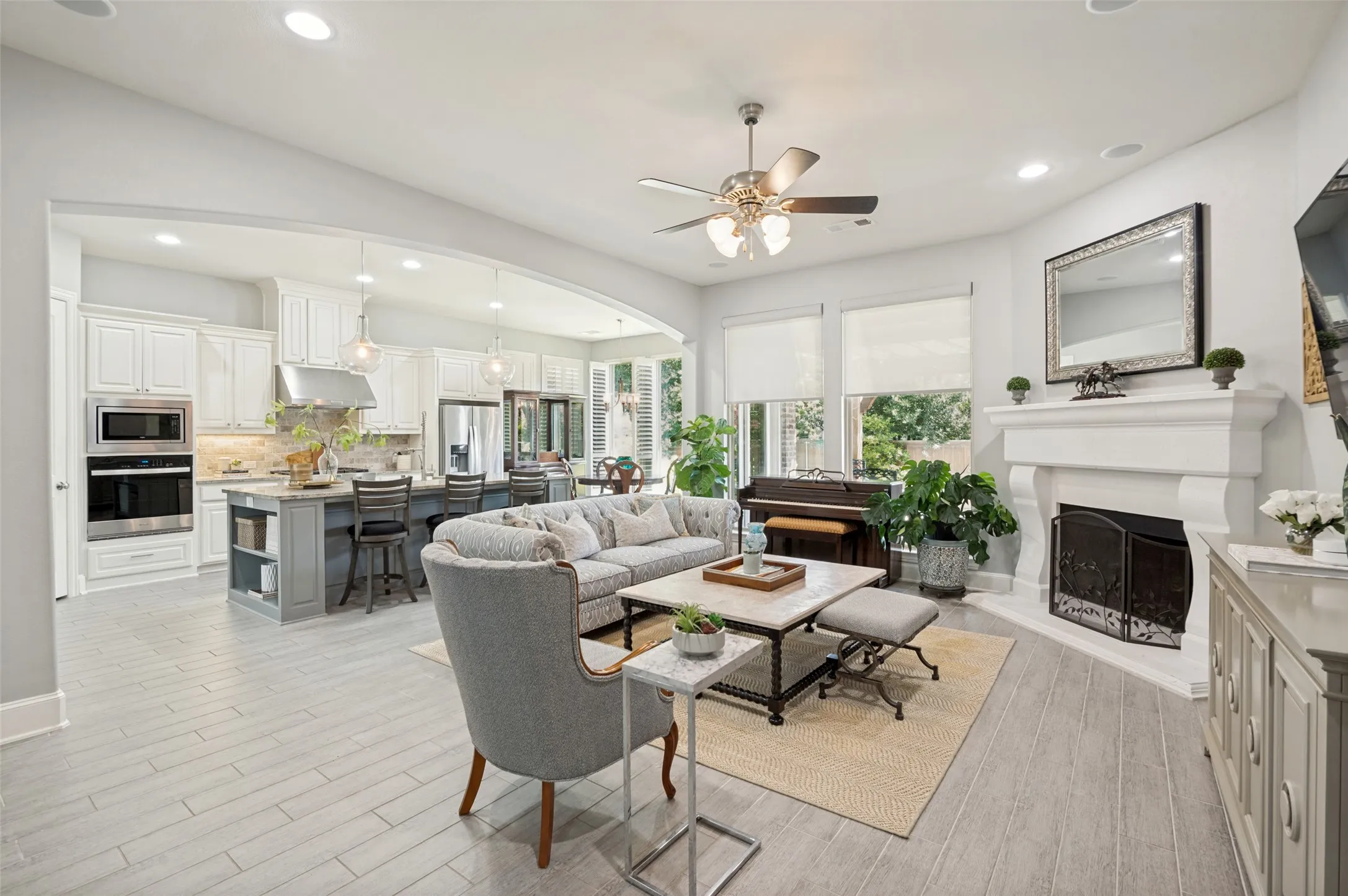 Inviting family room with a cozy fireplace, expansive windows, and an open-concept layout that flows seamlessly into the chef's kitchen and breakfast room. Filled with natural light, this space is perfect for everyday living and entertaining.