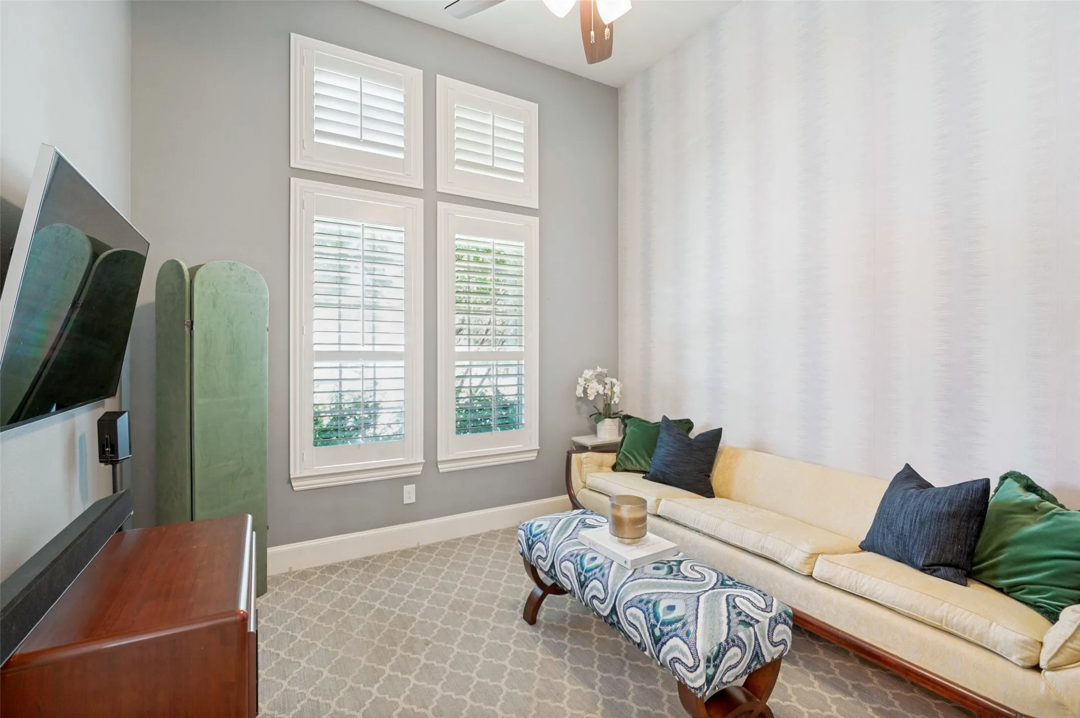 Bright and inviting office with large windows, plantation shutters, and plenty of natural light, offering a comfortable and productive workspace.