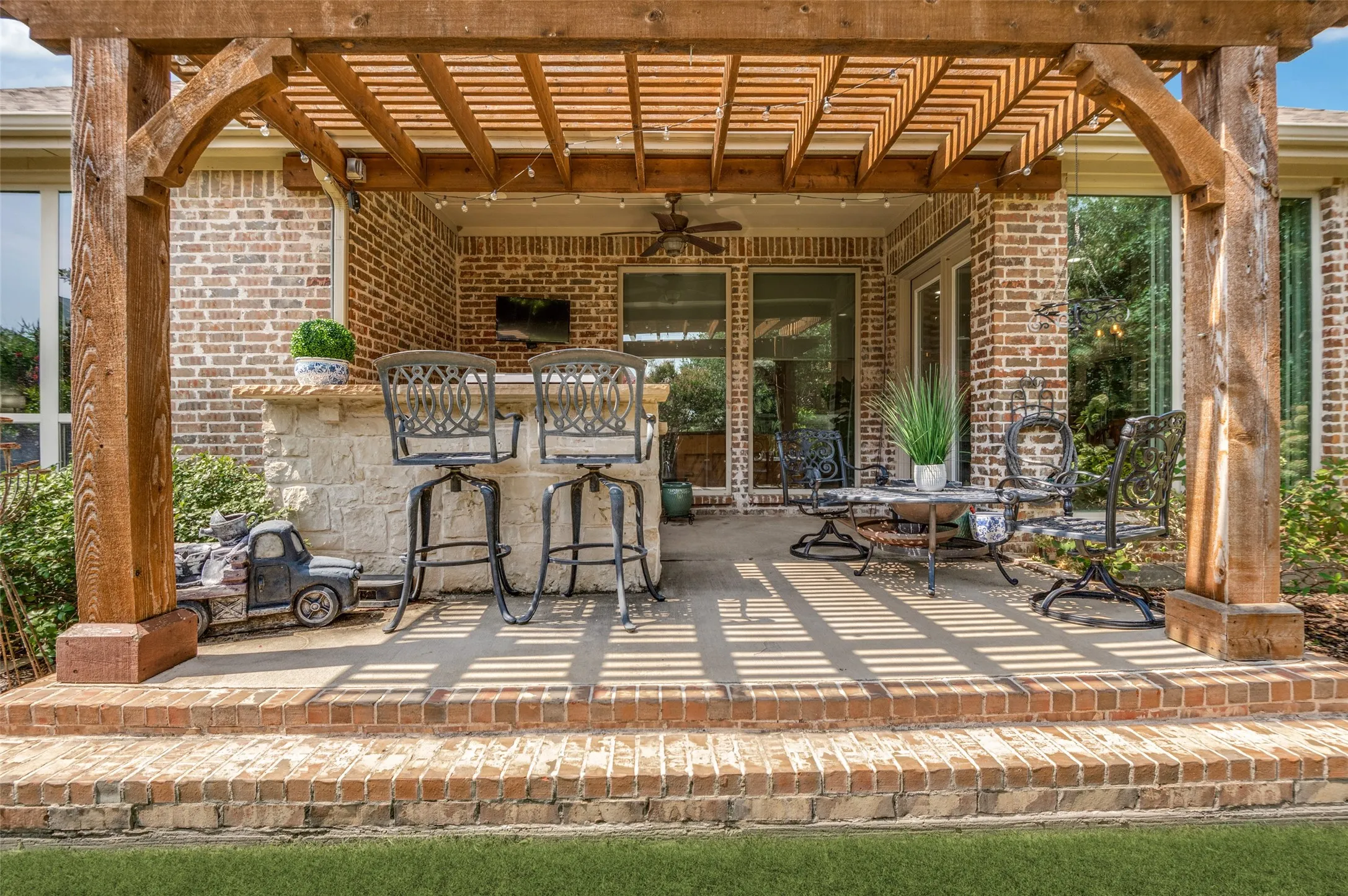 Enjoy year-round outdoor living under the custom cedar pergola featuring a built-in grilling station, bar seating, and multiple gathering areas. The beautifully landscaped backyard creates the perfect setting for entertaining family and friends or relaxing in your own private retreat.