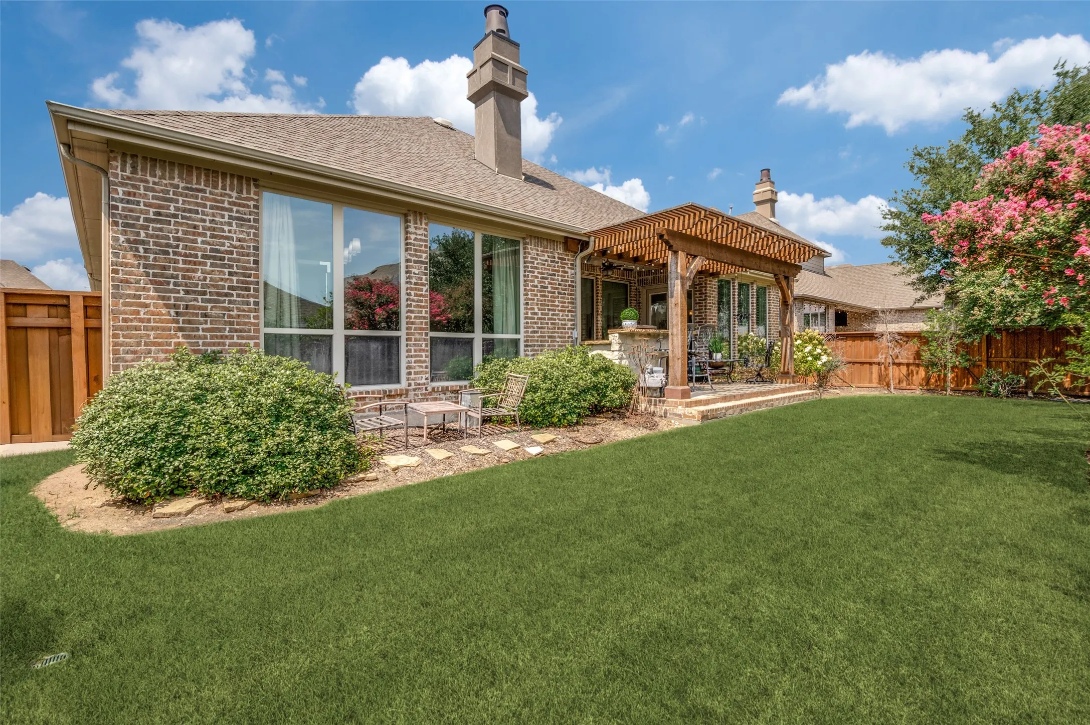 Step outside to an exceptional outdoor retreat featuring a custom cedar pergola, and beautifully manicured lawn surrounded by mature landscaping. A perfect setting for entertaining or unwinding in complete privacy.